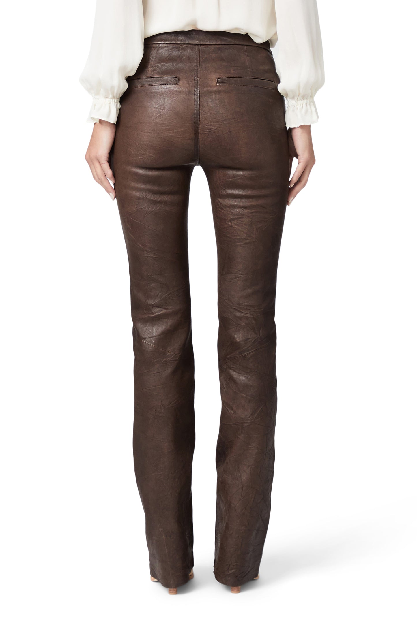 Brown leather pants worn by a person on a white background