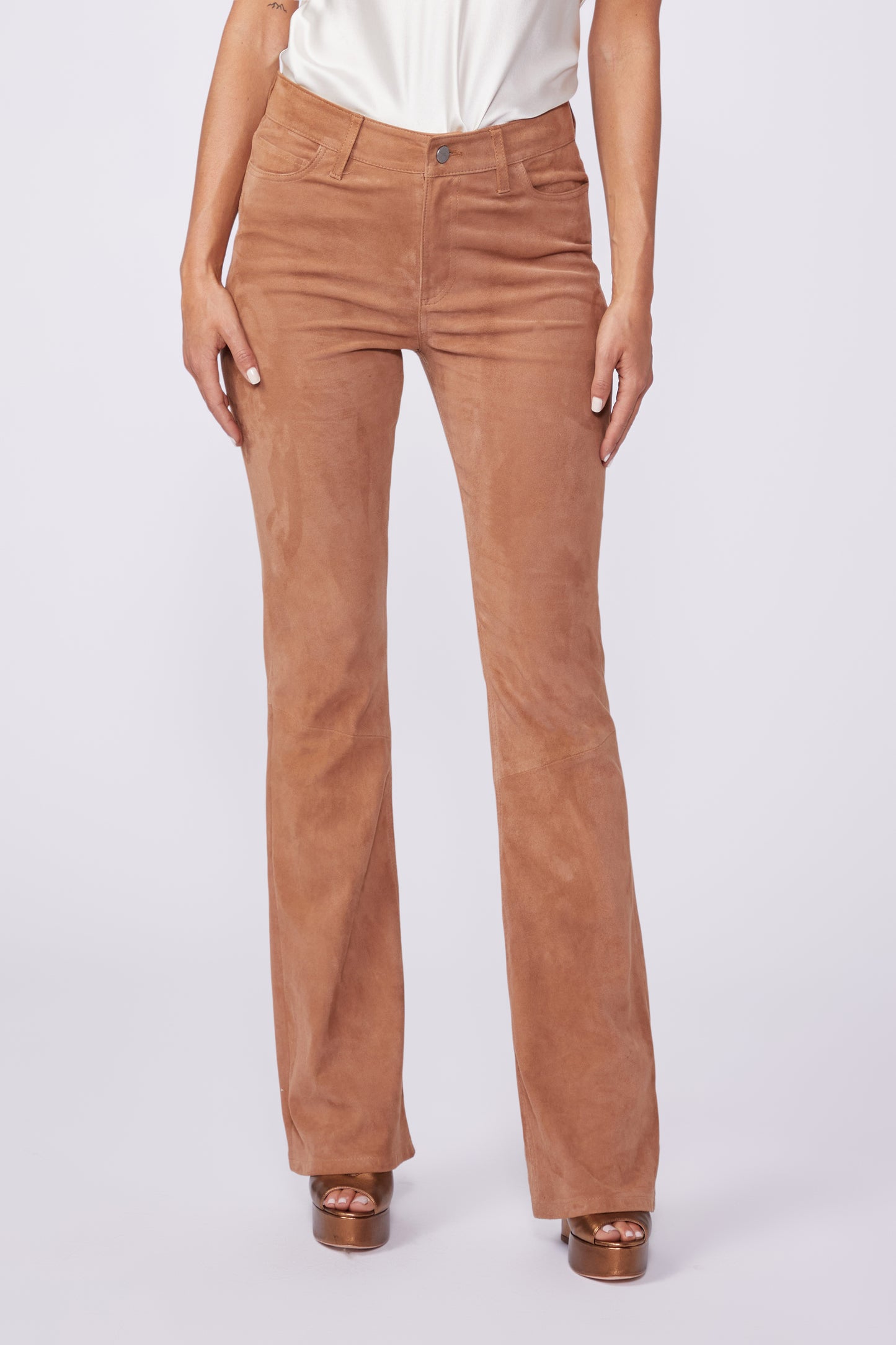Brown pants worn by a person on a white background