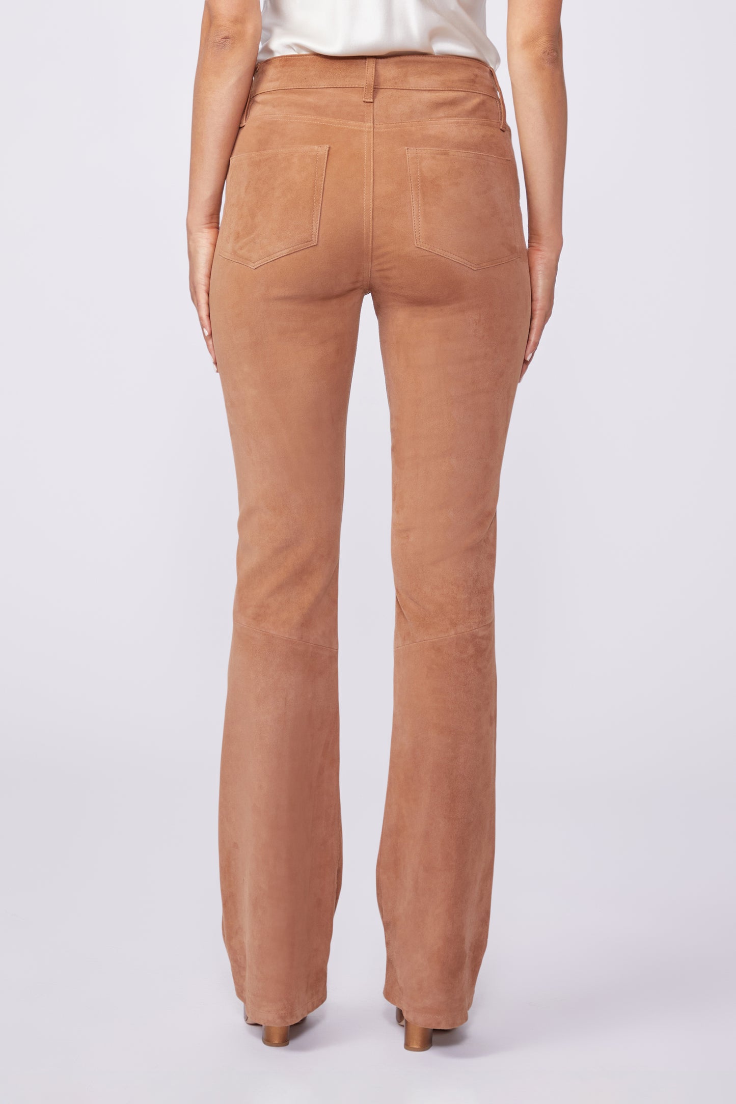 Brown pants worn by a person on a white background