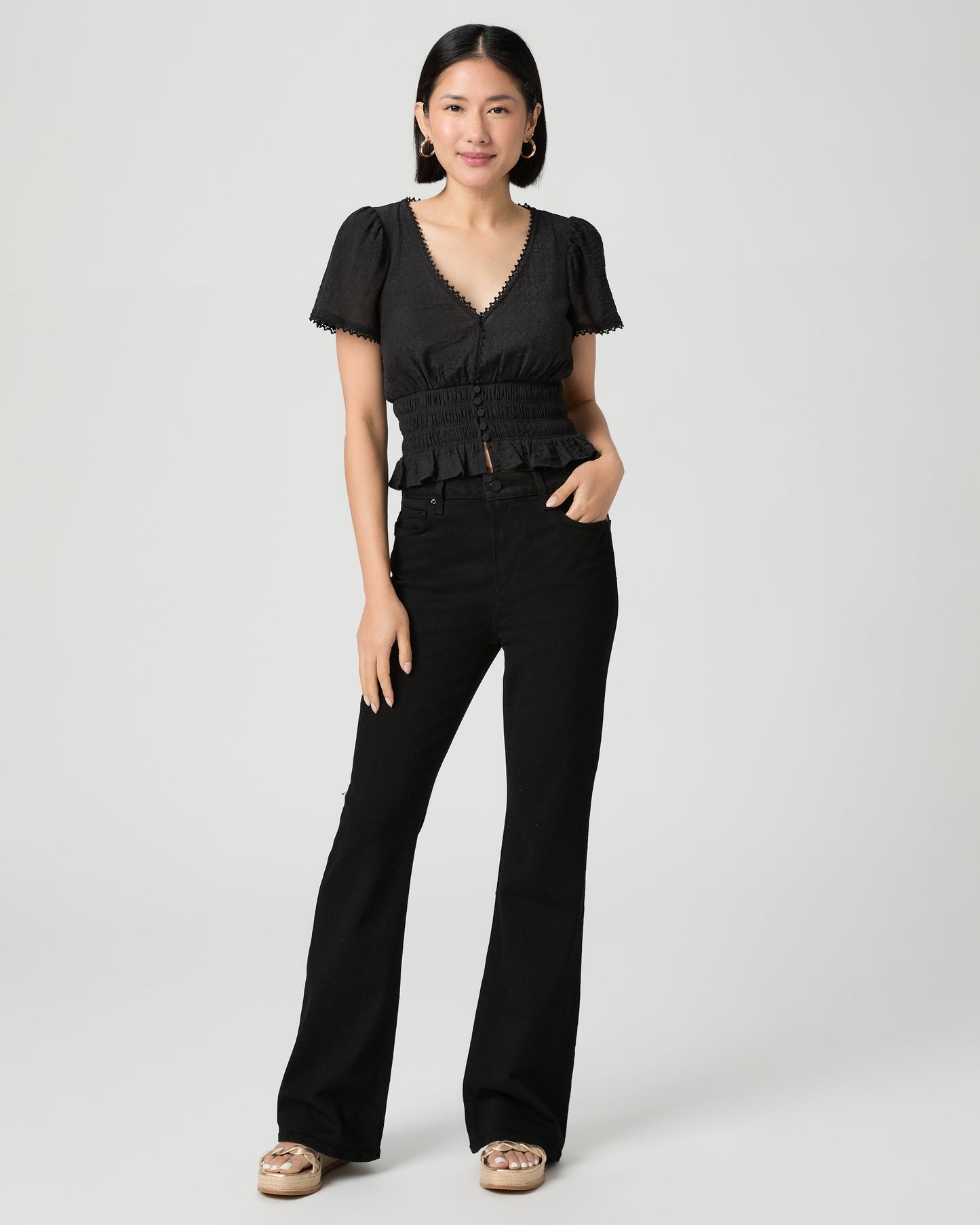 Woman wearing a black outfit with a white background