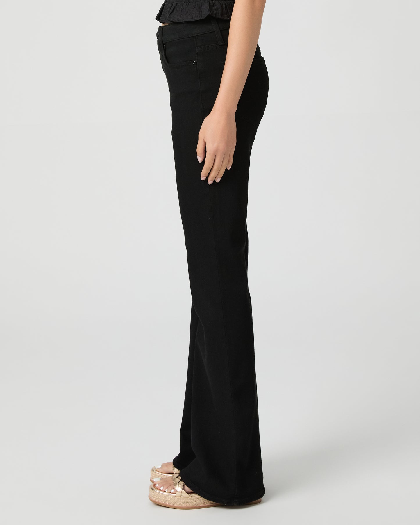 Woman wearing a black outfit with a white background