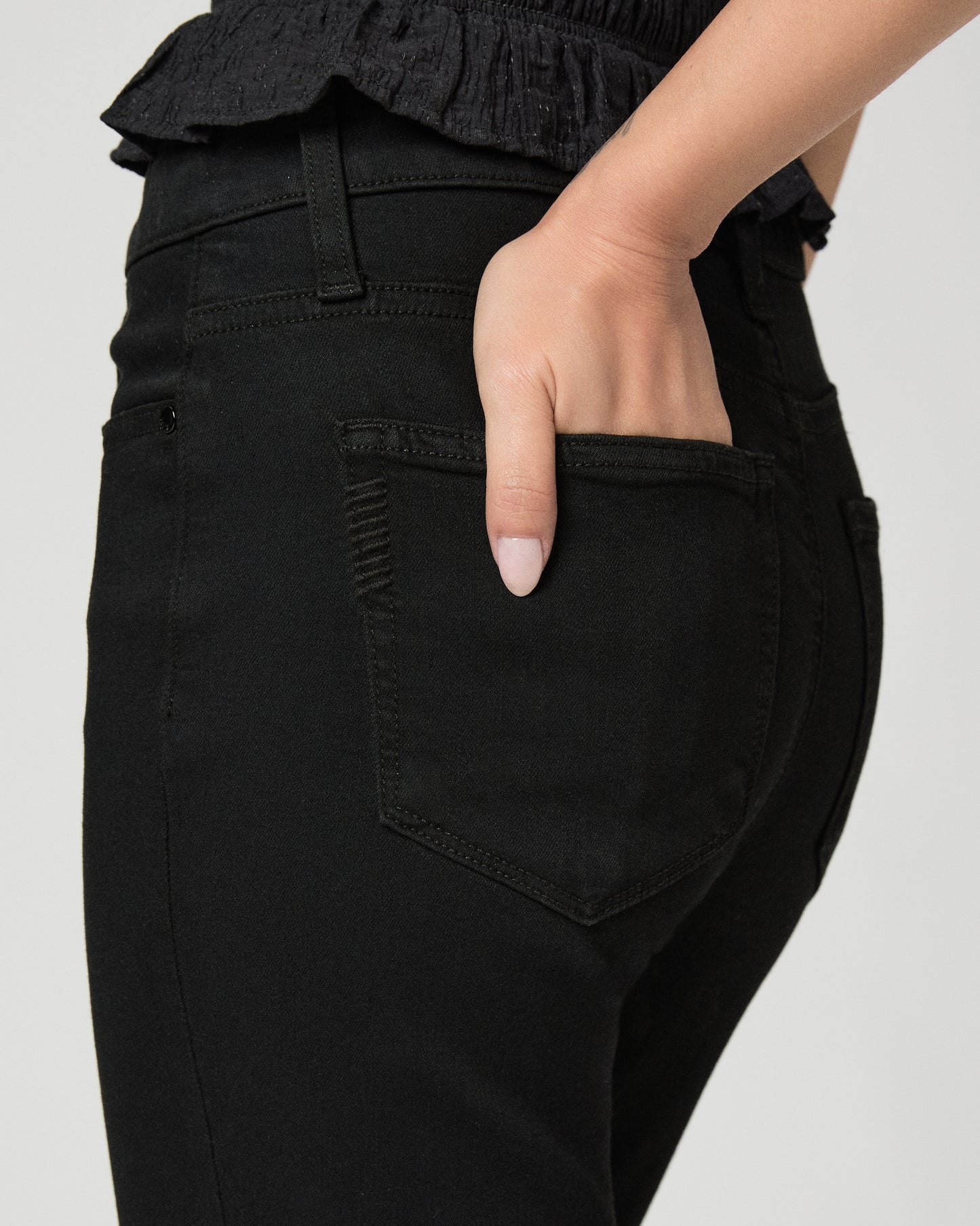 Woman wearing a black outfit with a white background