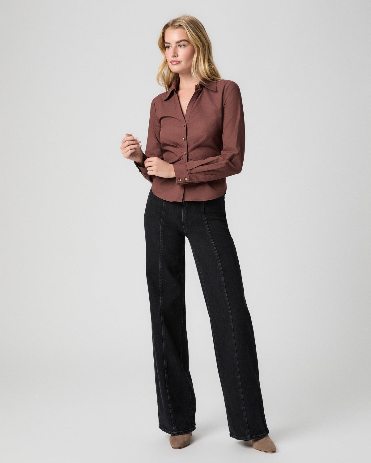 Alera Shirt in French Press brown; model stands facing forward touching a button, worn with black seamed wide leg jeans and tan heels