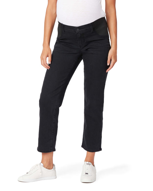 Person wearing black pants and white sneakers on a white background