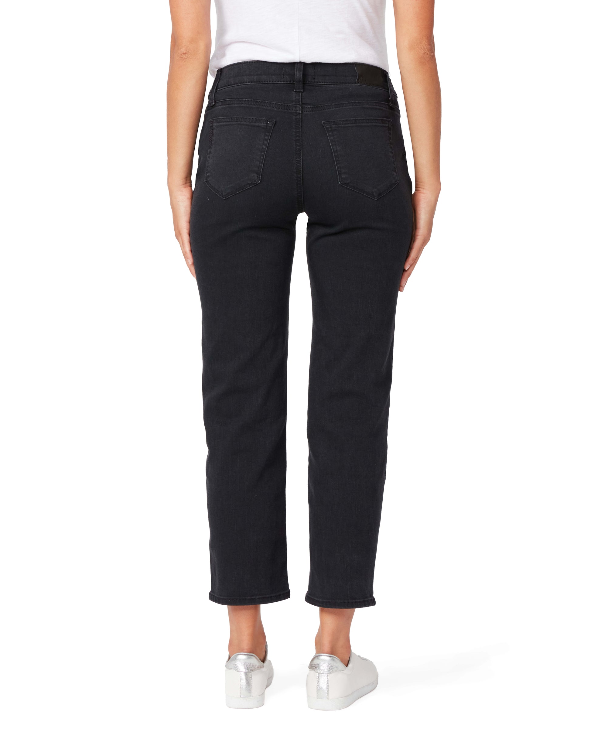Person wearing black jeans on a white background