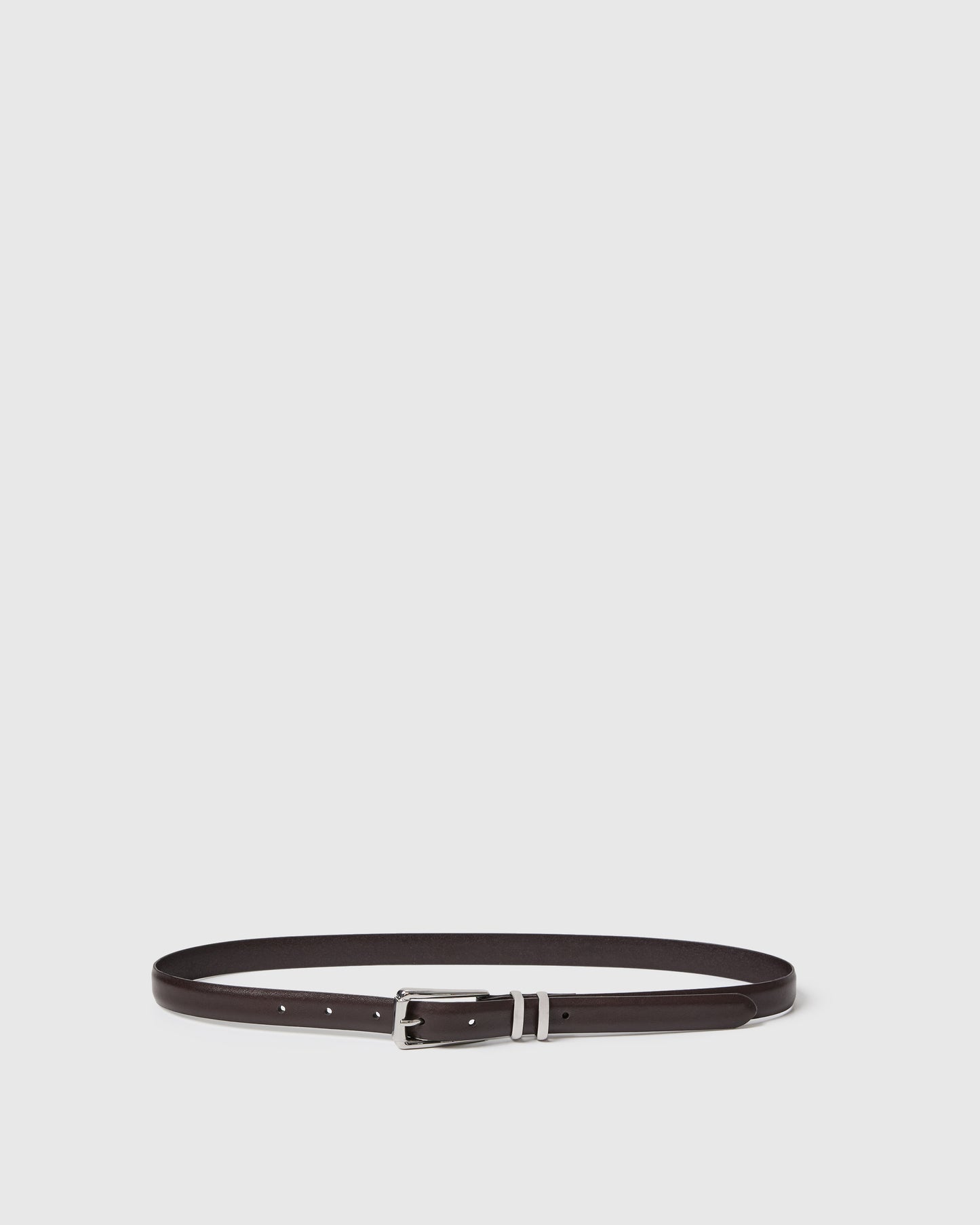 Chocolate belt with silver buckle on a light gray background.
