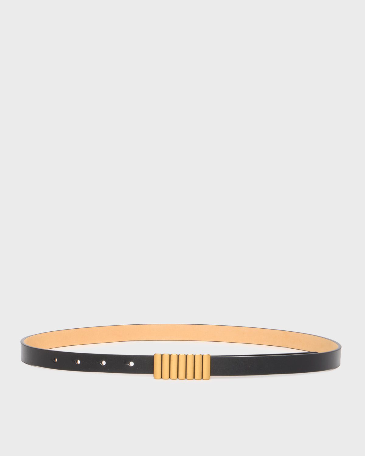 A minimalist black leather belt with a wide tan interior lining and a central gold-toned textured rectangular buckle, displayed horizontally on a light gray background.