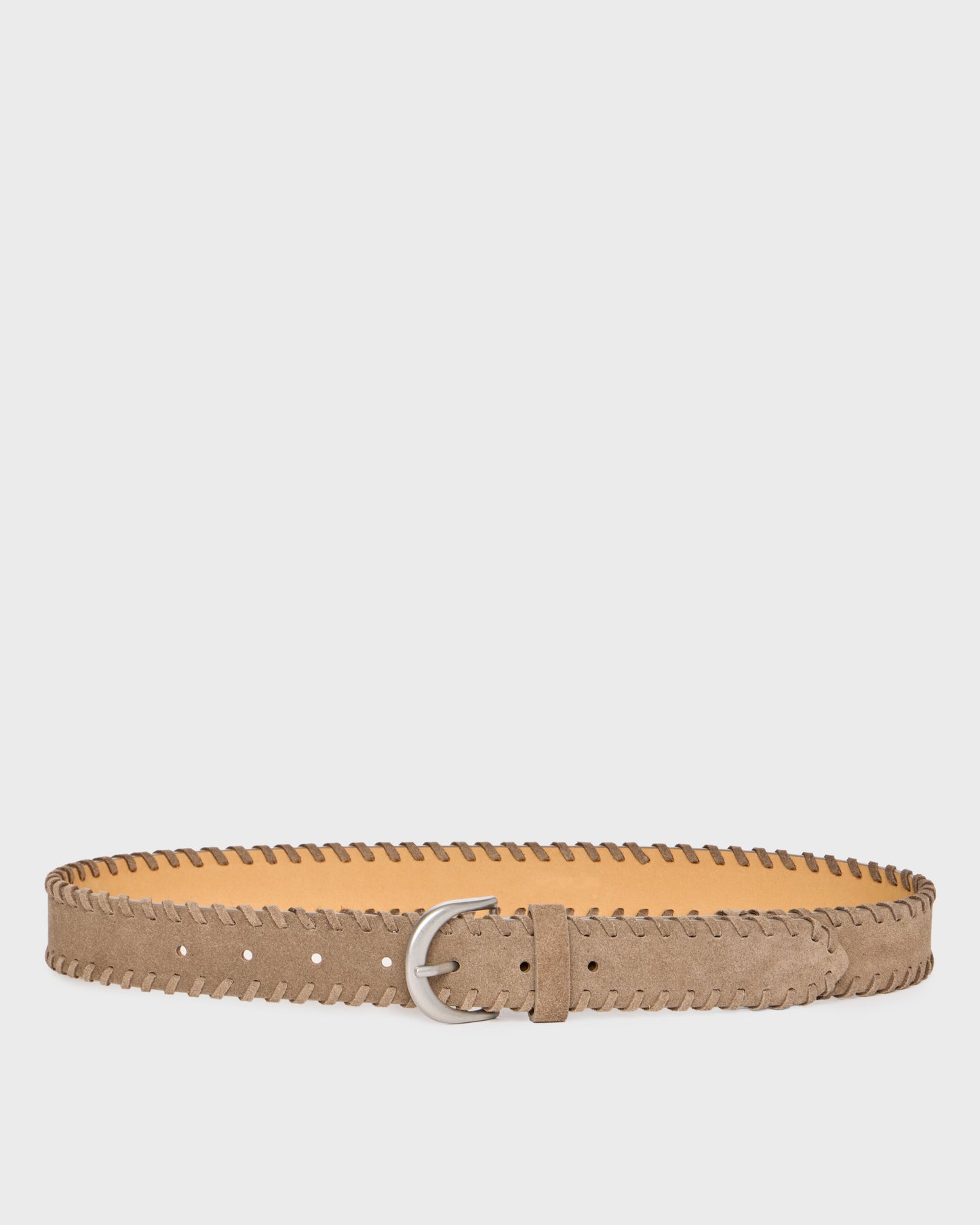 A light brown suede belt with a zigzag stitched edge and a silver metal buckle, displayed horizontally against a light gray background.
