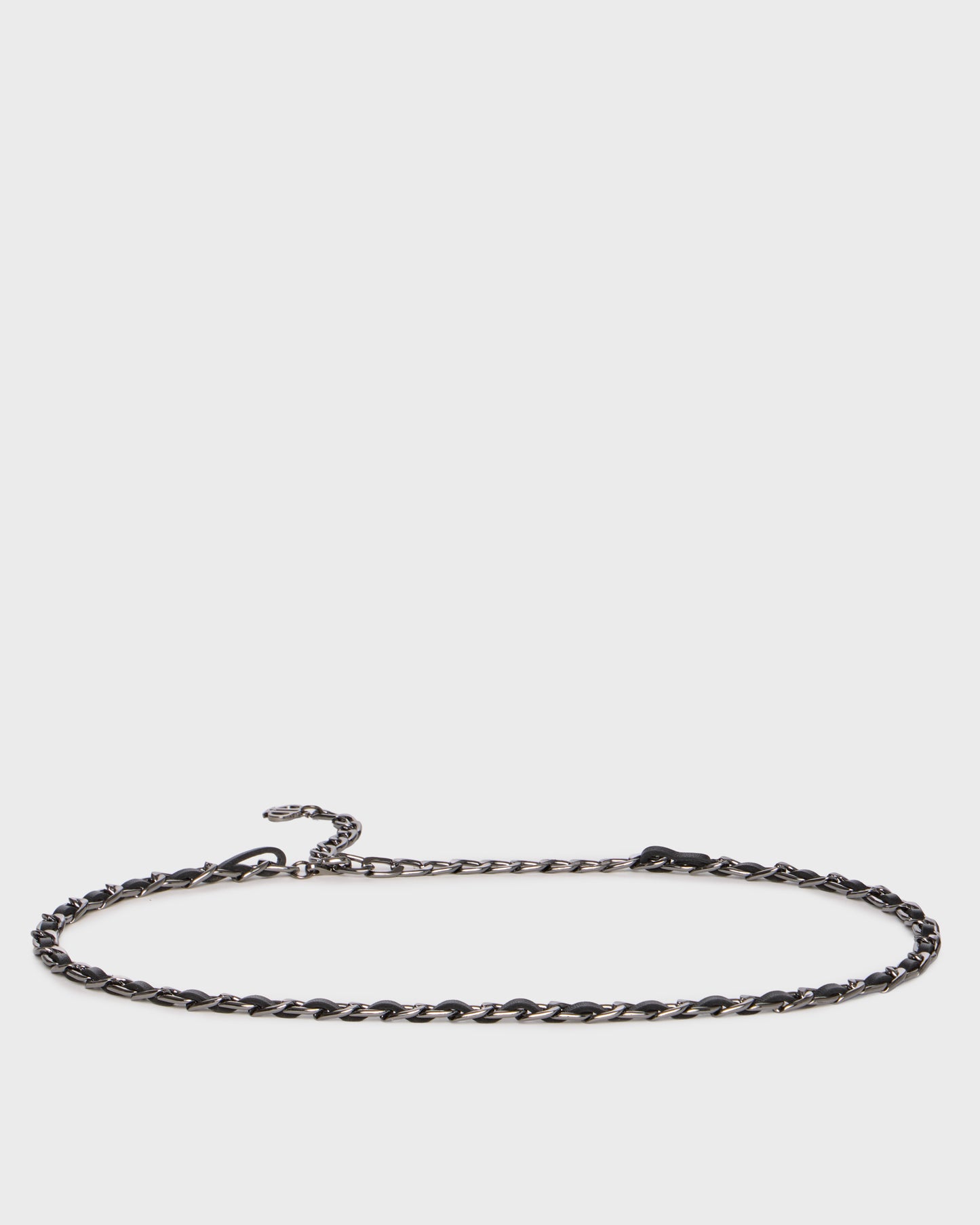 A dark metallic twisted chain necklace with a lobster clasp and extender, displayed horizontally against a light gray background.