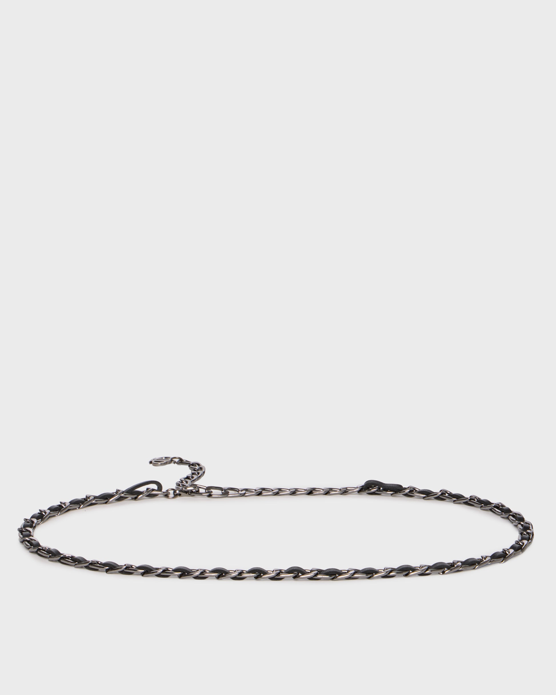 A dark metallic twisted chain necklace with a lobster clasp and extender, displayed horizontally against a light gray background.
