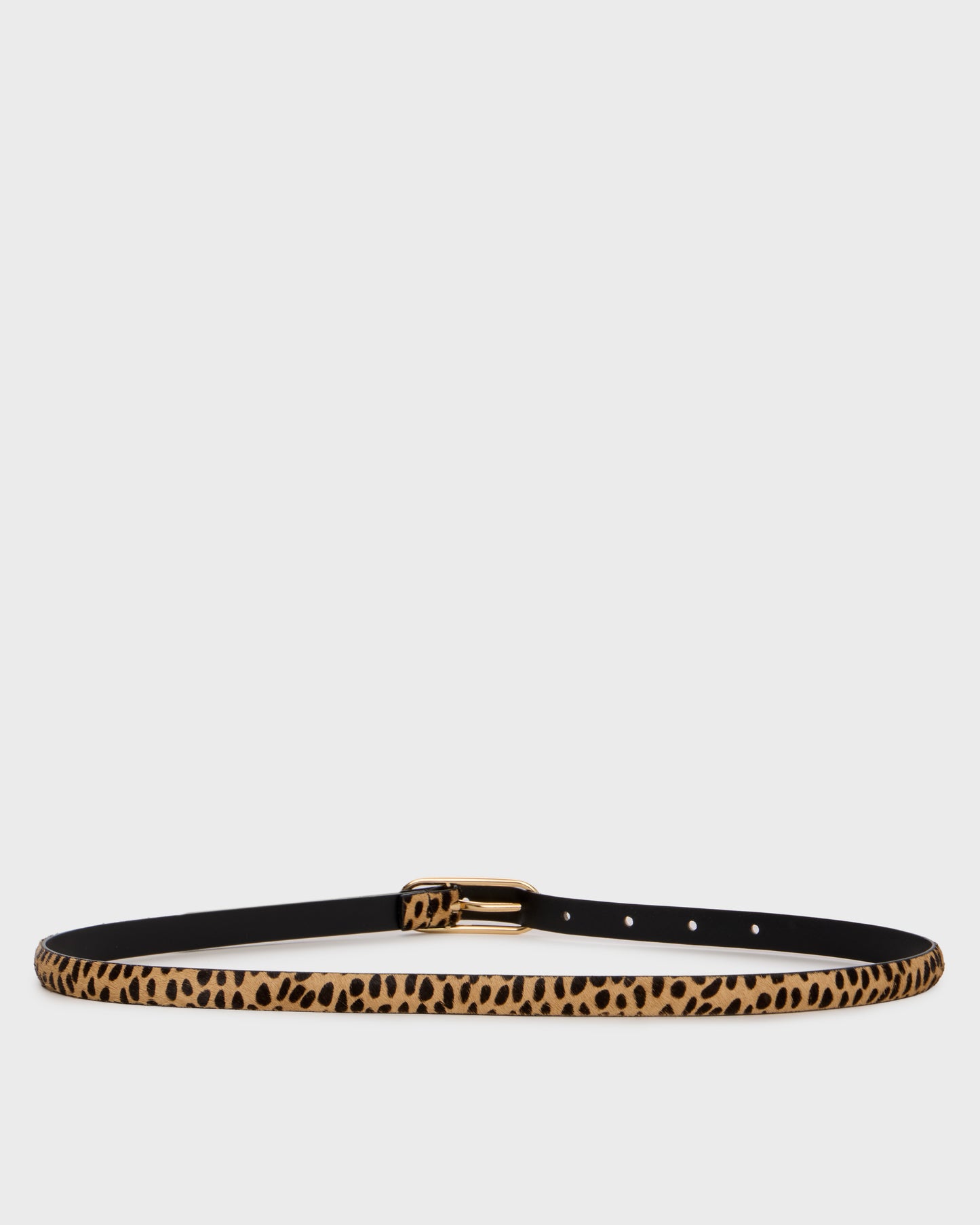 A slim belt with a black base and a tan leopard print pattern, finished with a gold-tone buckle, shown against a light gray background.