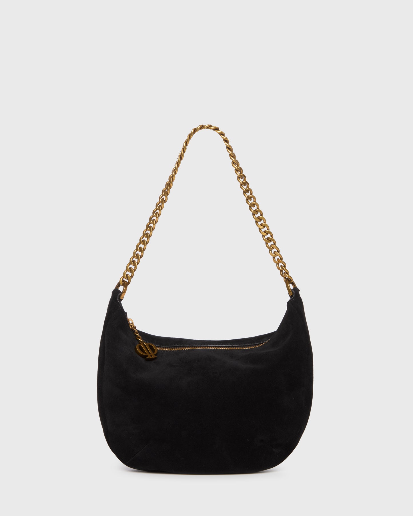 A black suede crescent-shaped shoulder bag with a gold-tone chain strap and a small gold logo charm, set against a plain light gray background.