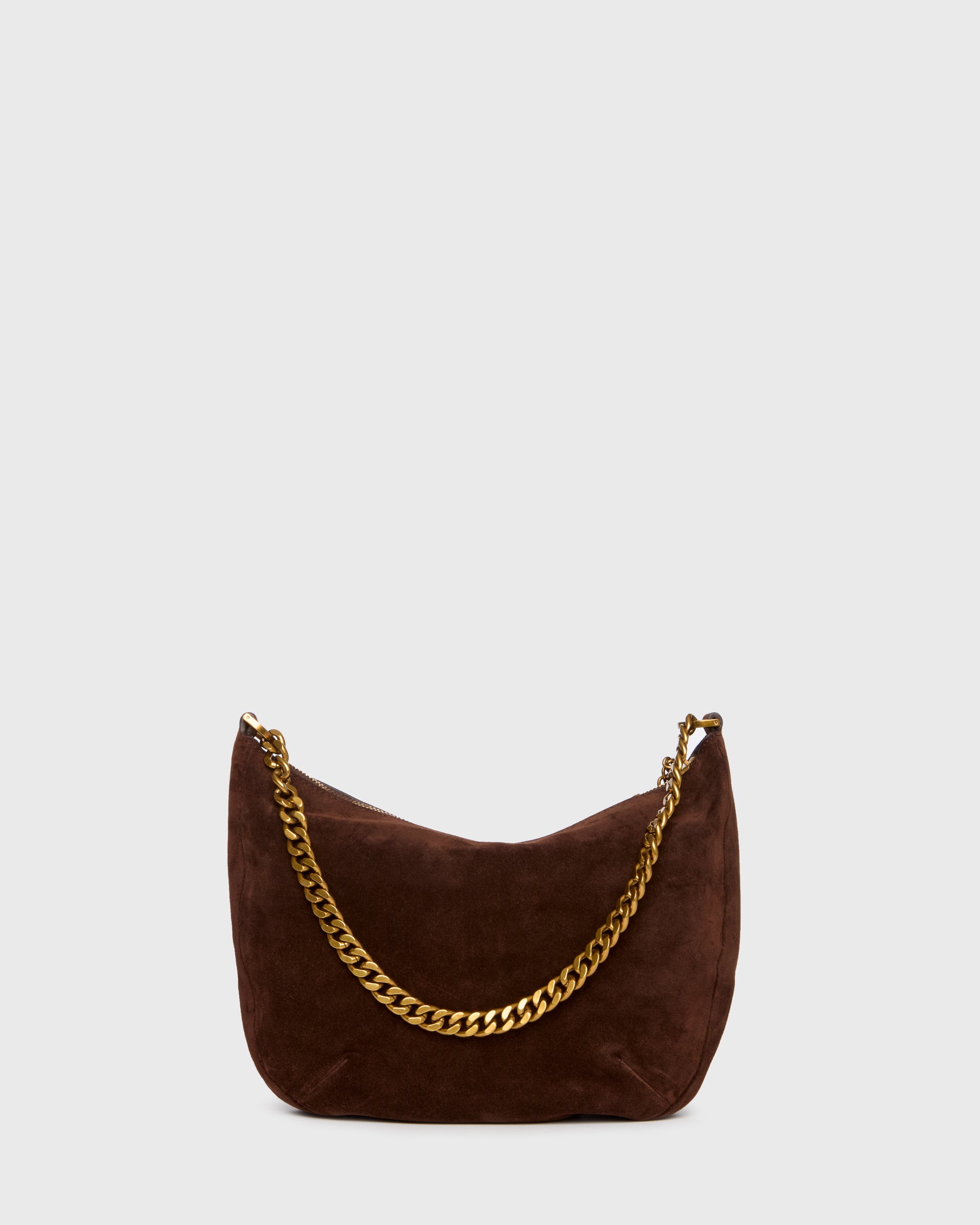 A dark brown suede crescent shoulder bag with a gold-tone chain link strap, shown against a light gray background.