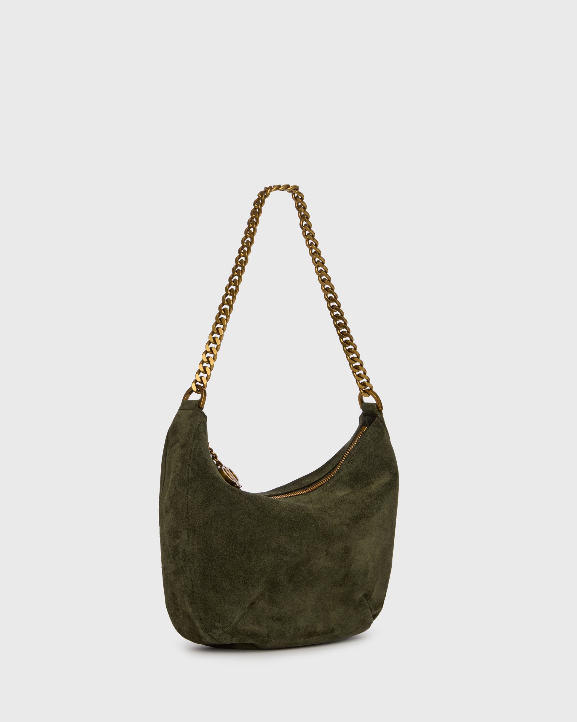 An olive green suede crescent-shaped shoulder bag with a gold-tone chain strap and a small gold logo charm, set against a plain light gray background.