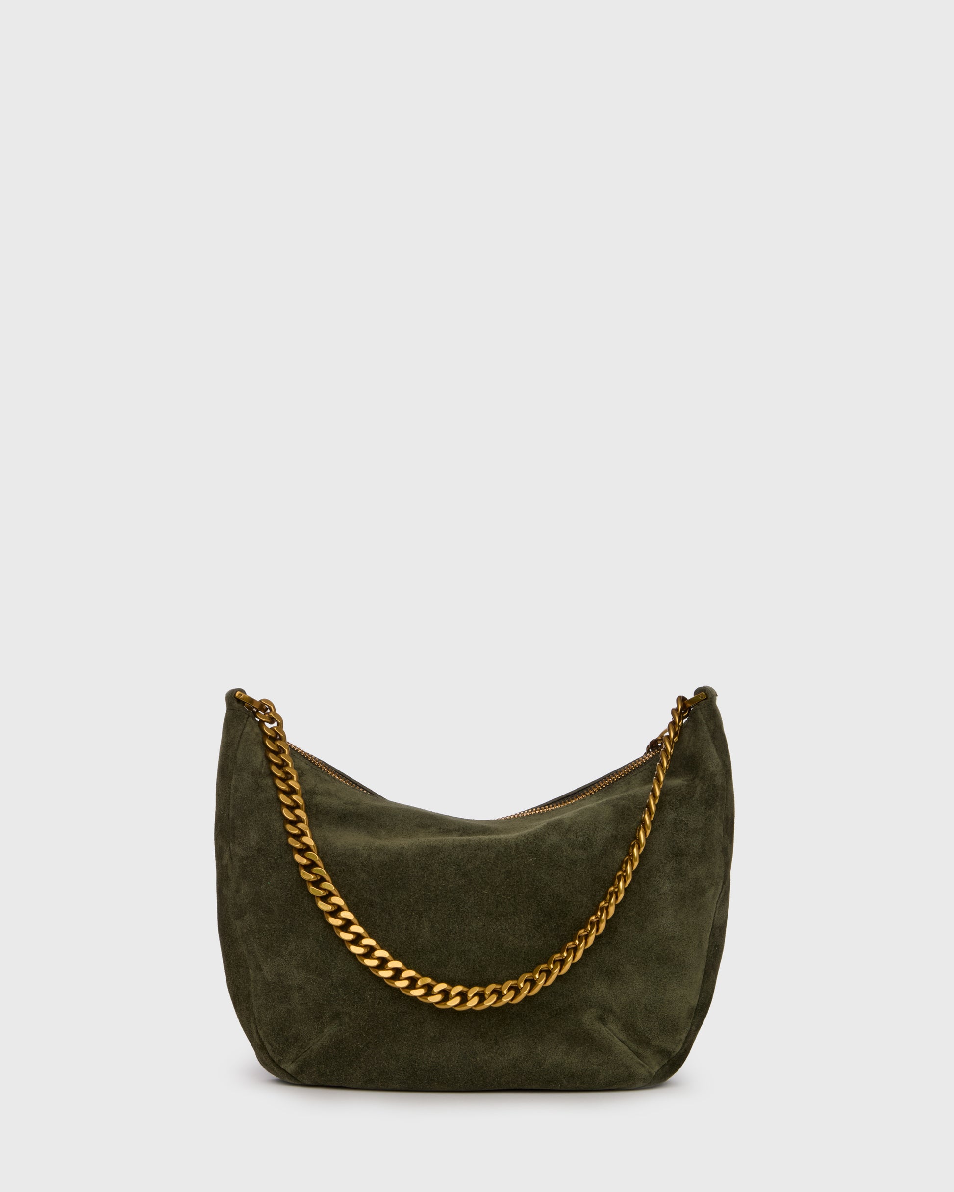 An olive green suede crescent-shaped shoulder bag with a gold-tone chain strap and a small gold logo charm, set against a plain light gray background.