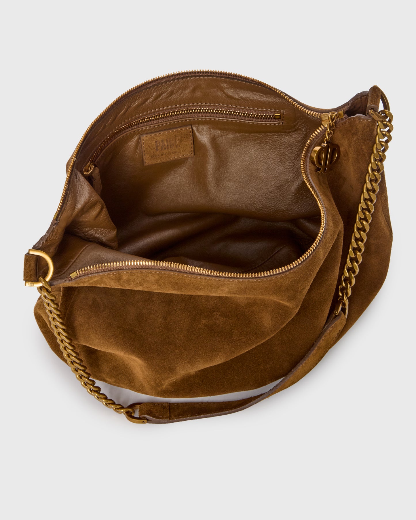 A brown suede shoulder bag with a gold-tone chain strap, shown from an overhead angle to display its interior lining and compartments on a light gray background.