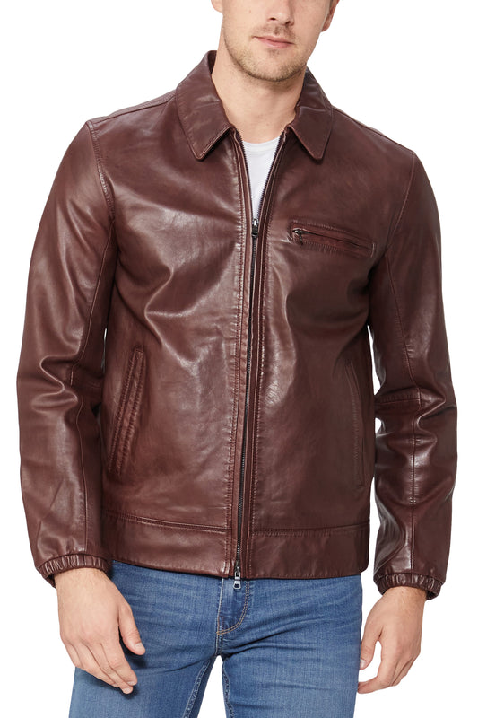Man wearing a brown leather jacket and blue jeans on a white background