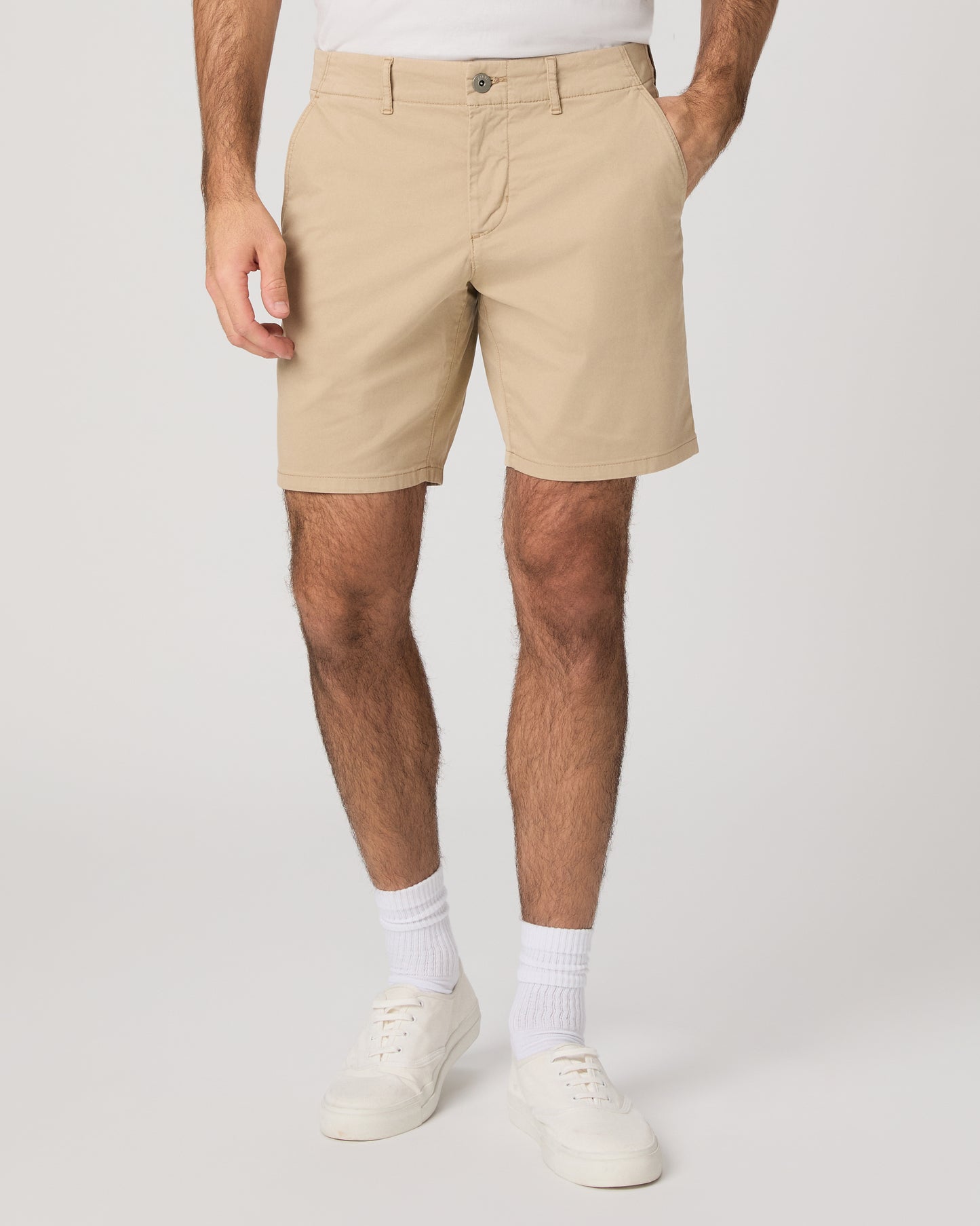 Men wearing beige color shorts paired with a white tee and white sneakers