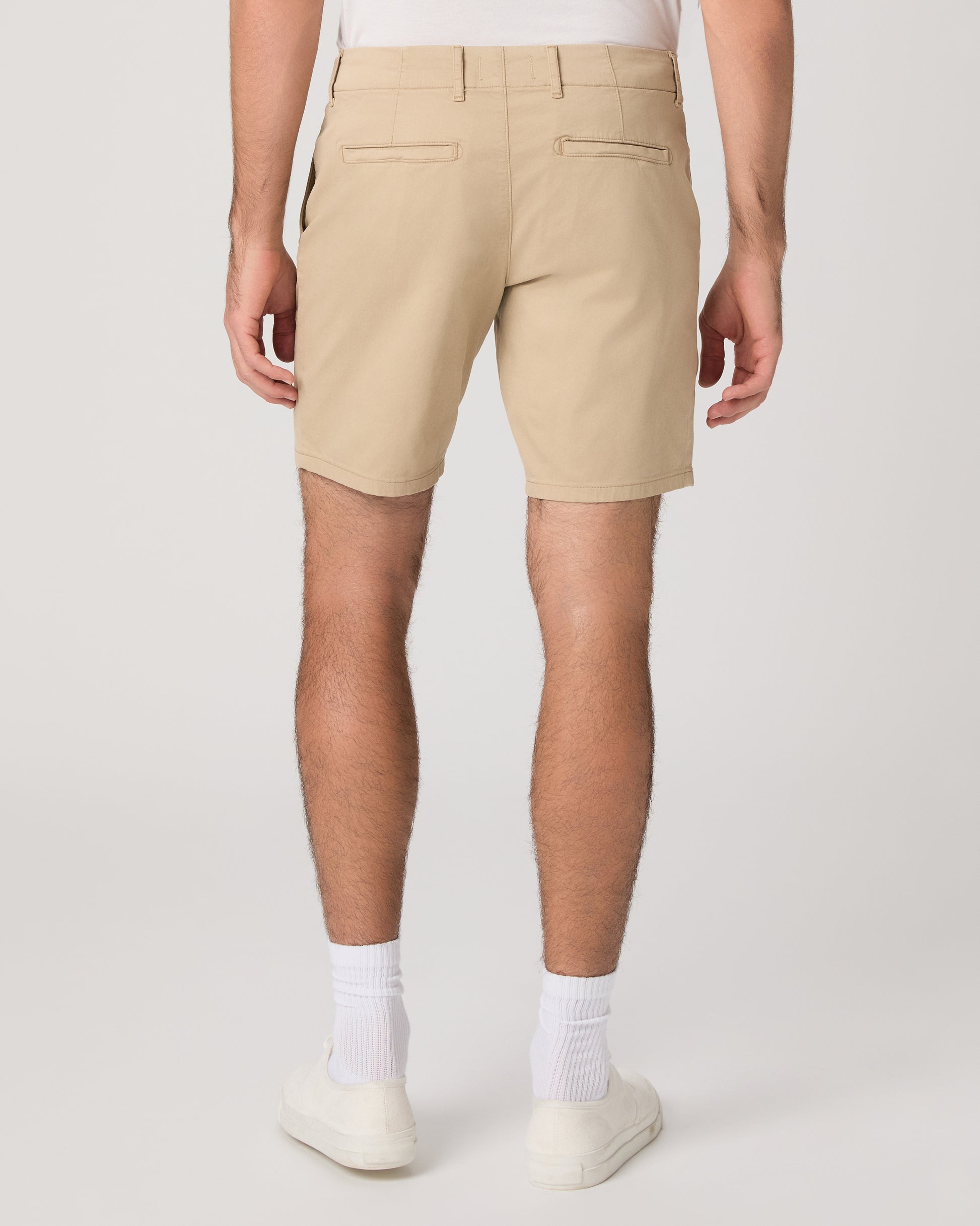 Men wearing beige color shorts paired with a white tee and white sneakers