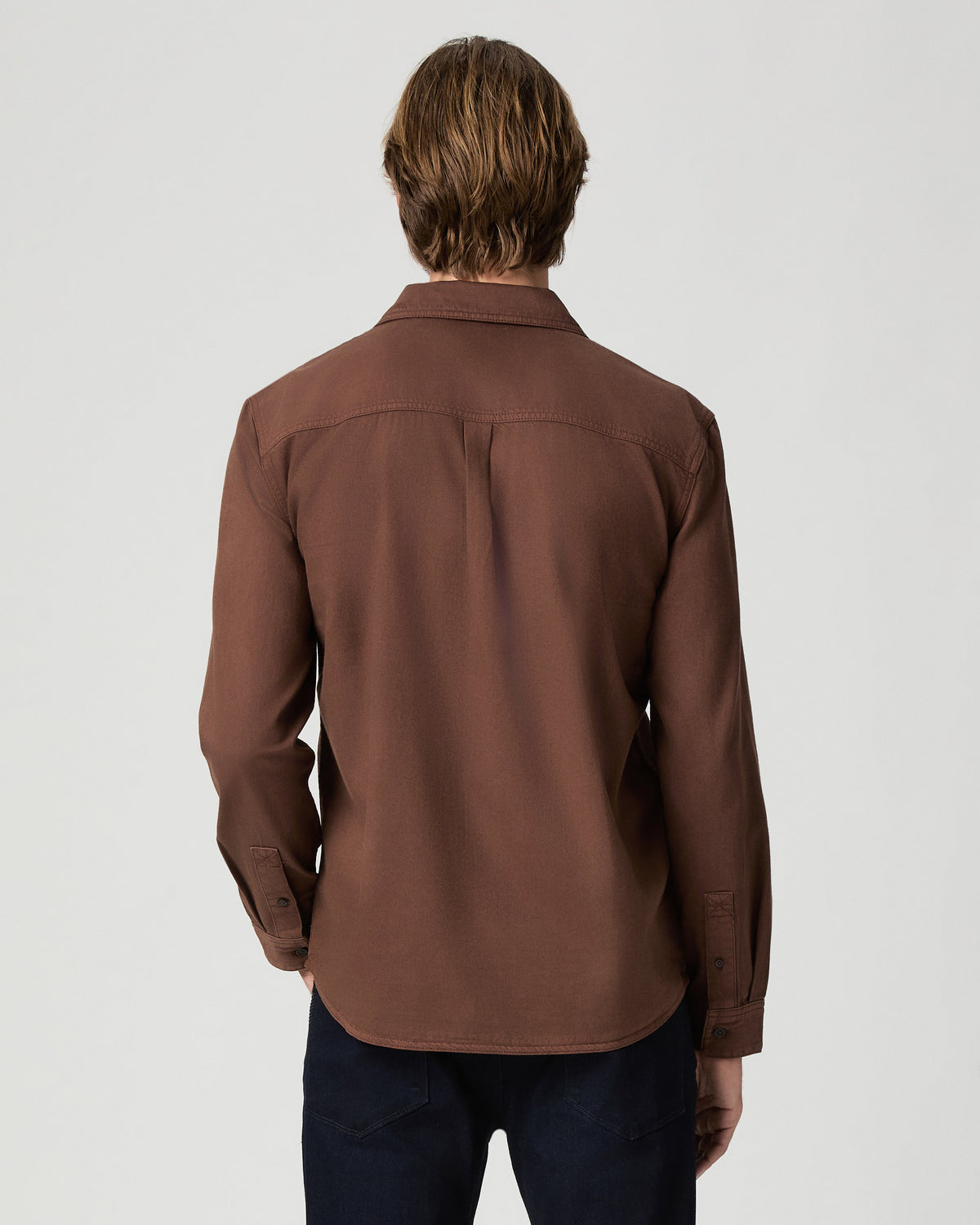 Back view of model wearing the Martin Shirt in Vintage Sepia Clay with dark jeans