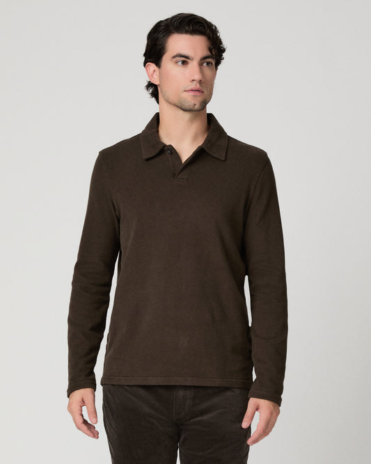Man wearing a brown shirt and brown pants against a white background