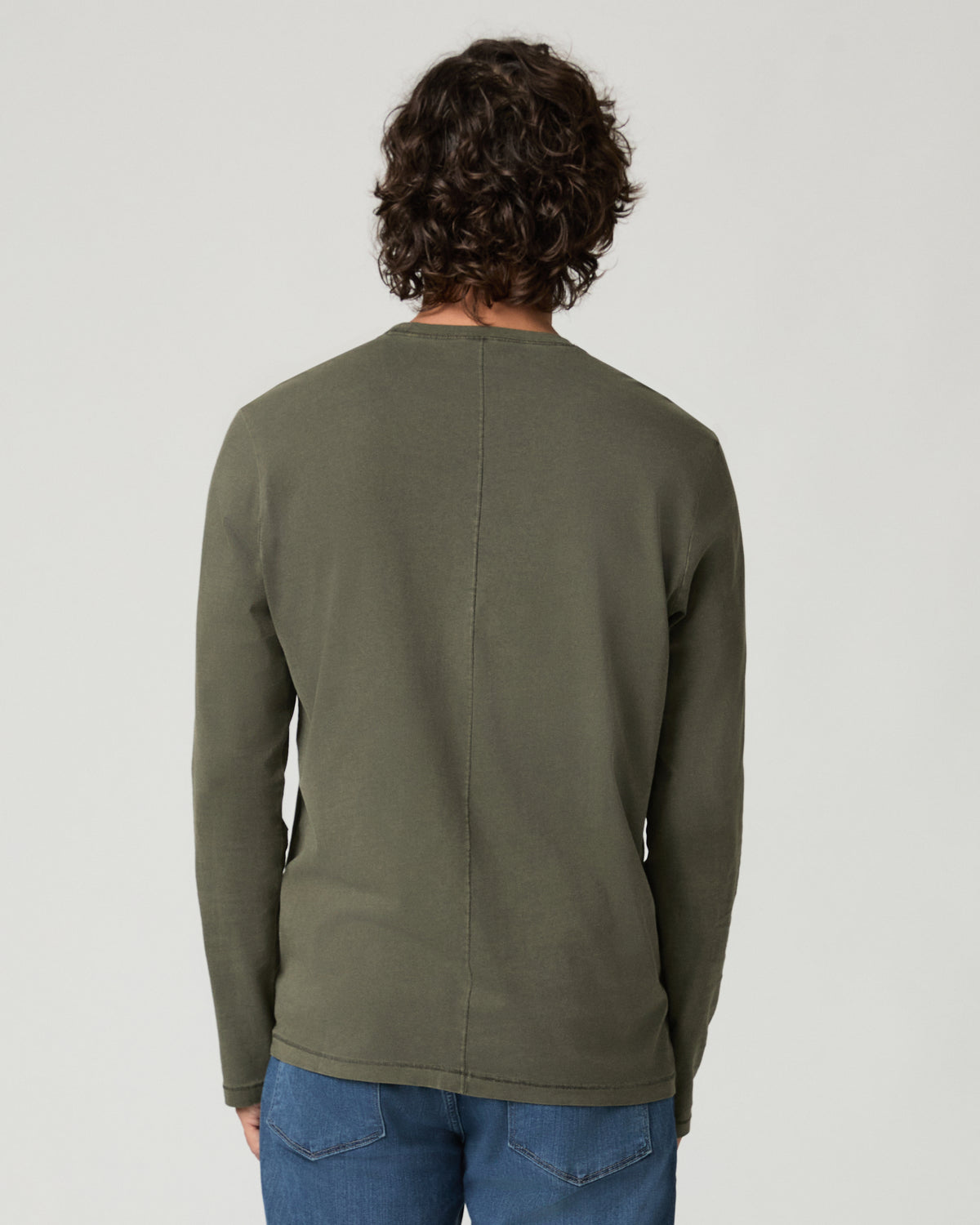 Back view of a man wearing the vintage fatigue green Enzo Shirt, showing the center back seam and raw-edge crew neckline.