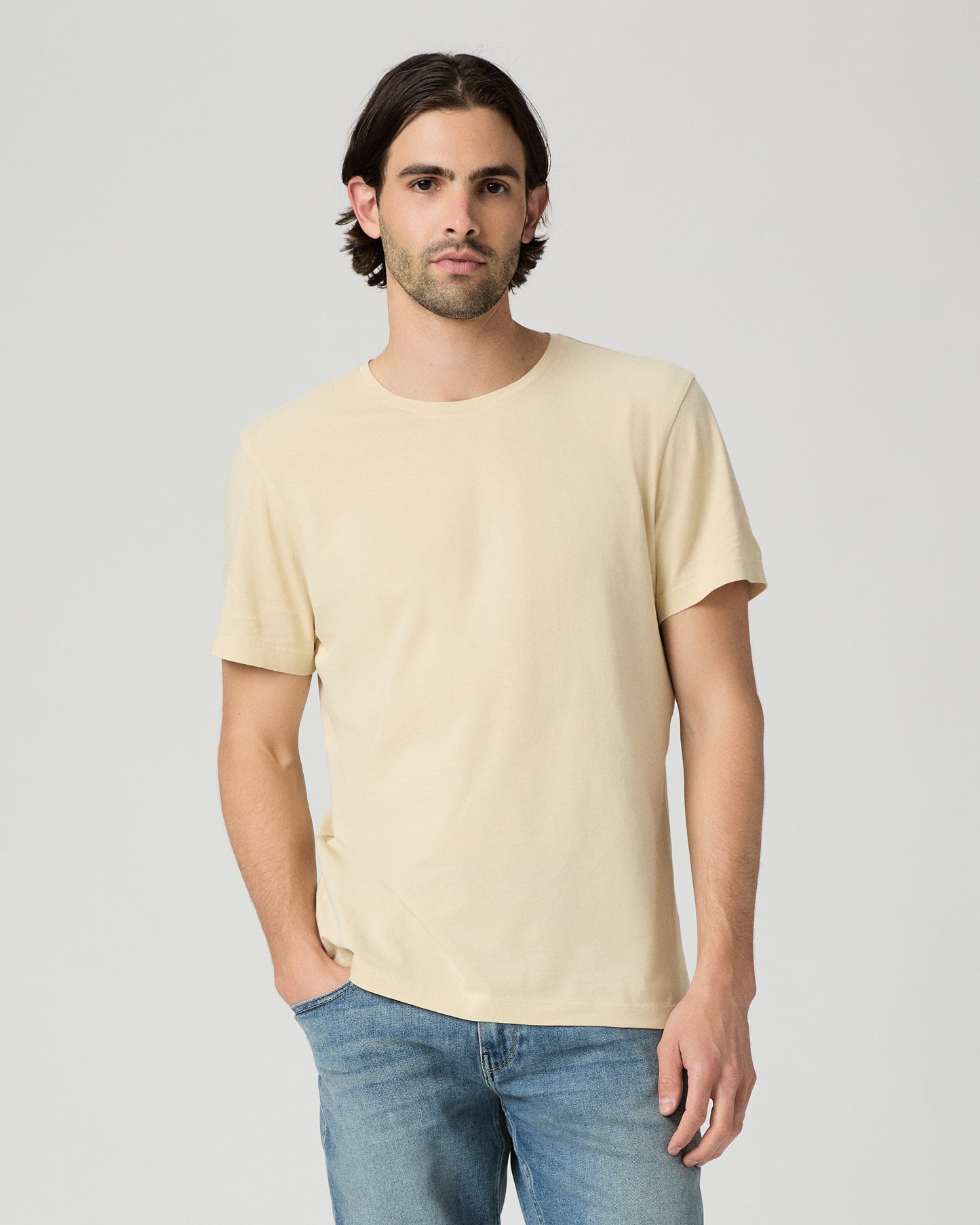 Man wearing light yellow with a medium wash jeans