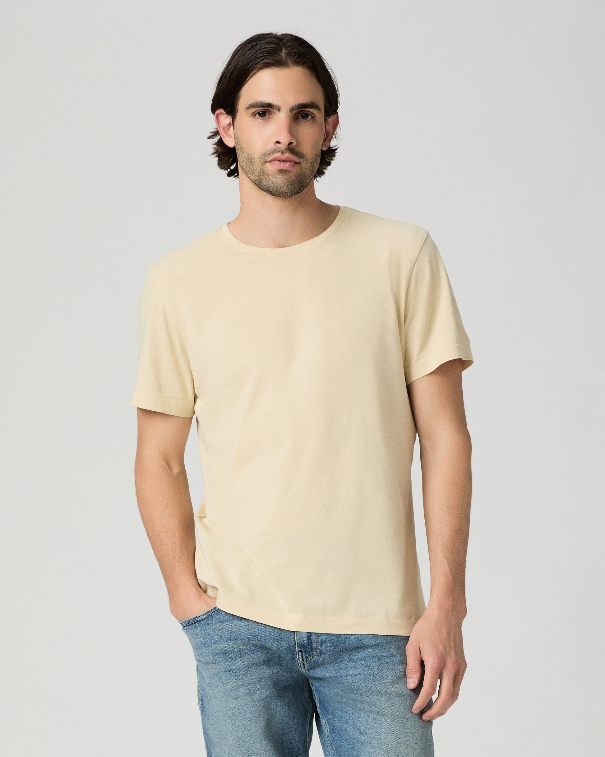 Man wearing light yellow with a medium wash jeans
