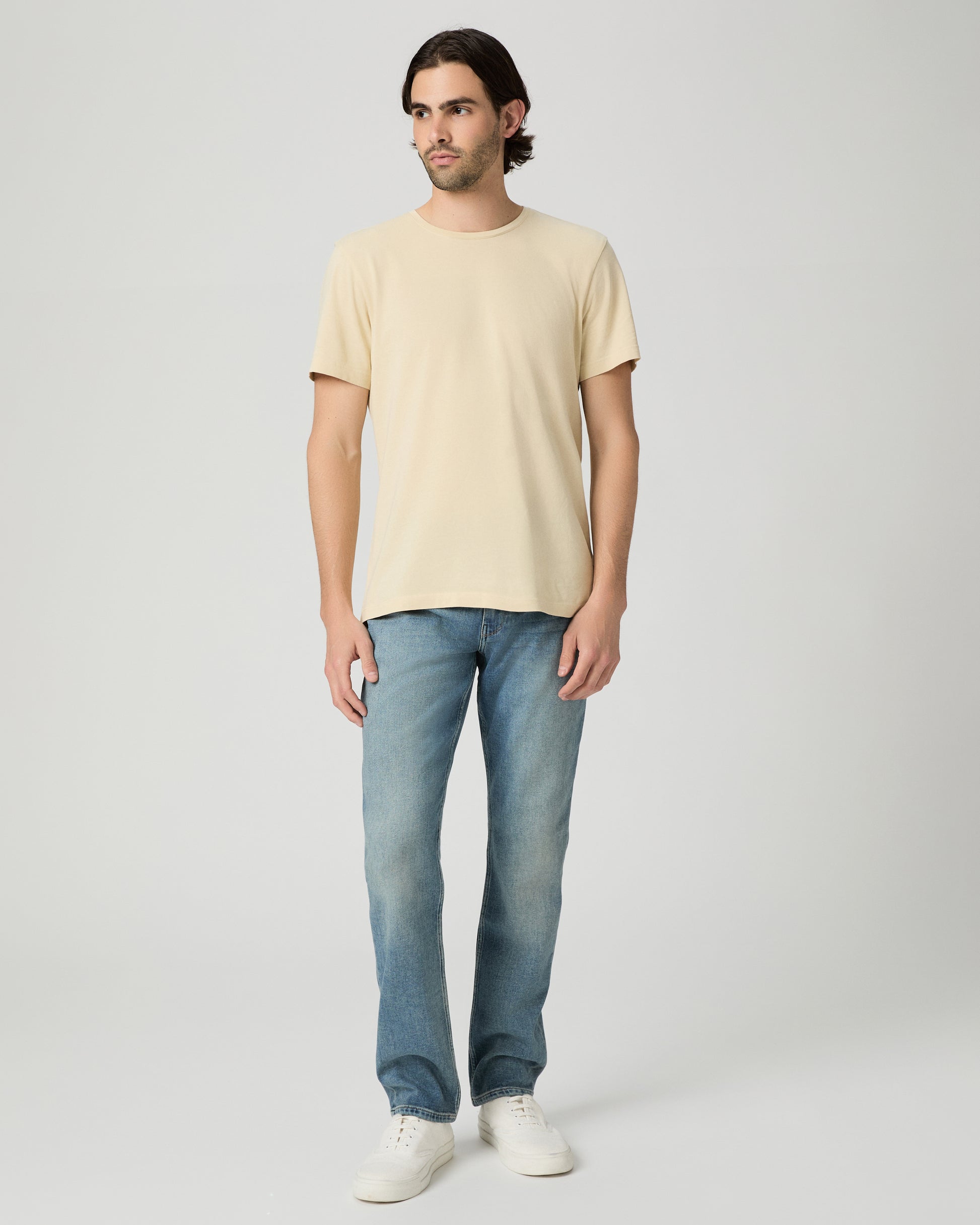 Man wearing light yellow with a medium wash jeans