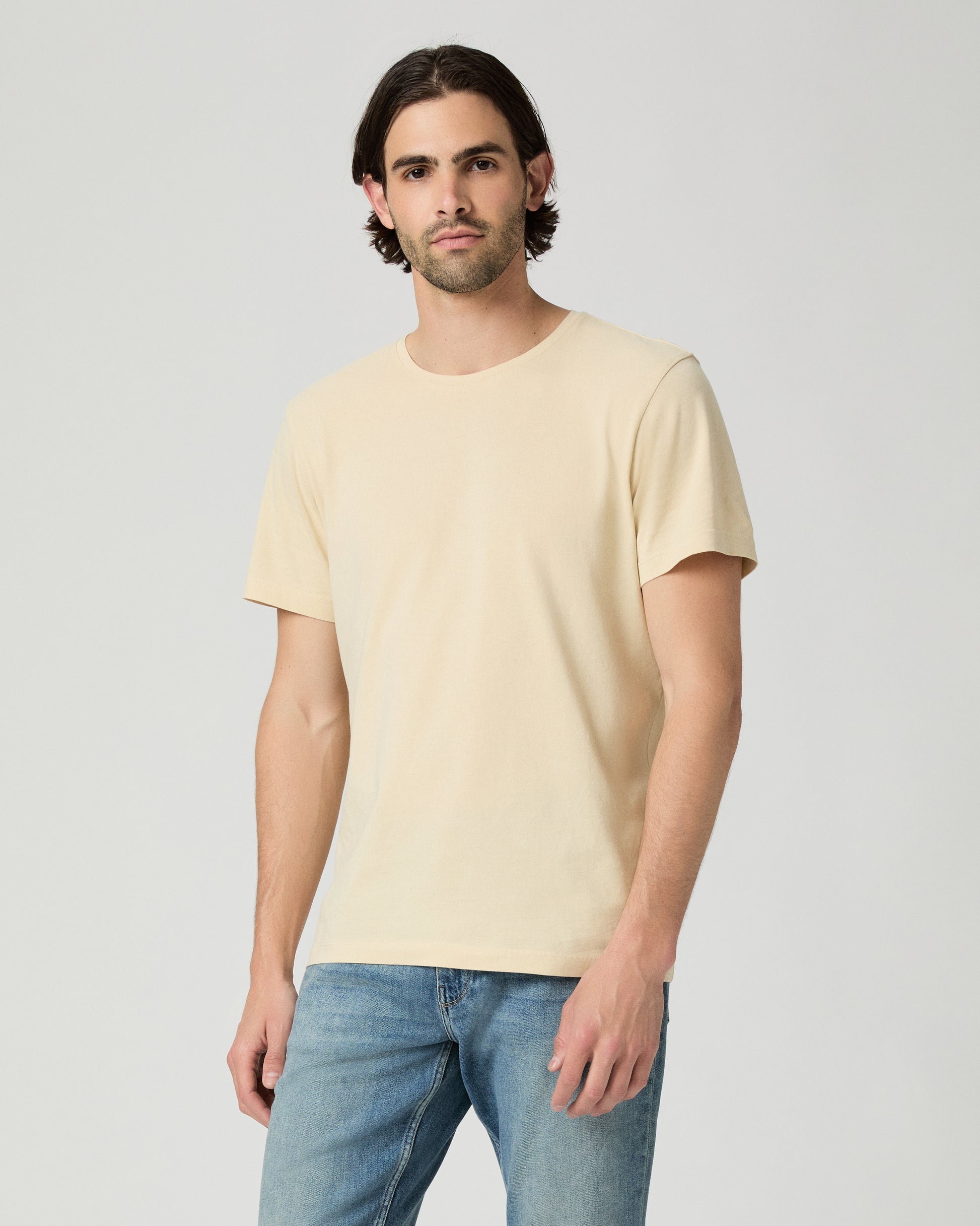 Man wearing light yellow with a medium wash jeans