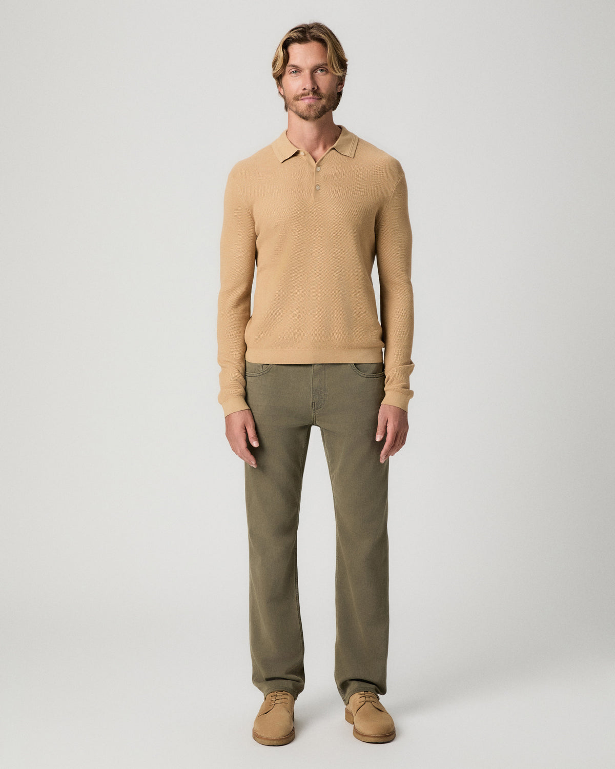 Full-length view of model standing with arms at his sides, wearing the Selwyn Sweater Polo in Brown Russet with olive pants and tan suede boots