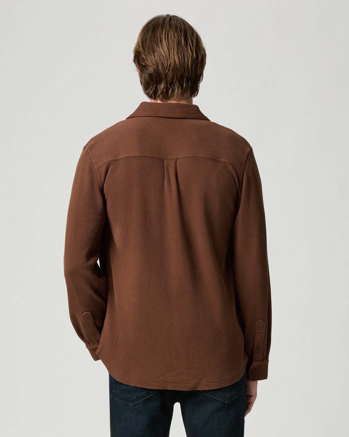 Back view of model wearing the Hollander Shirt in Sepia Clay with dark jeans