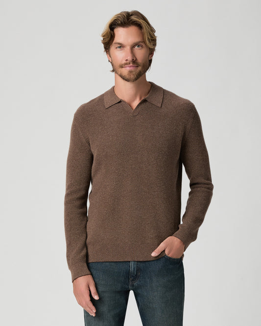 Model standing with one hand in his pocket, wearing the Otis Sweater Polo in Pecan Bark Combo, a brown heathered knit polo with an open collar, with dark jeans