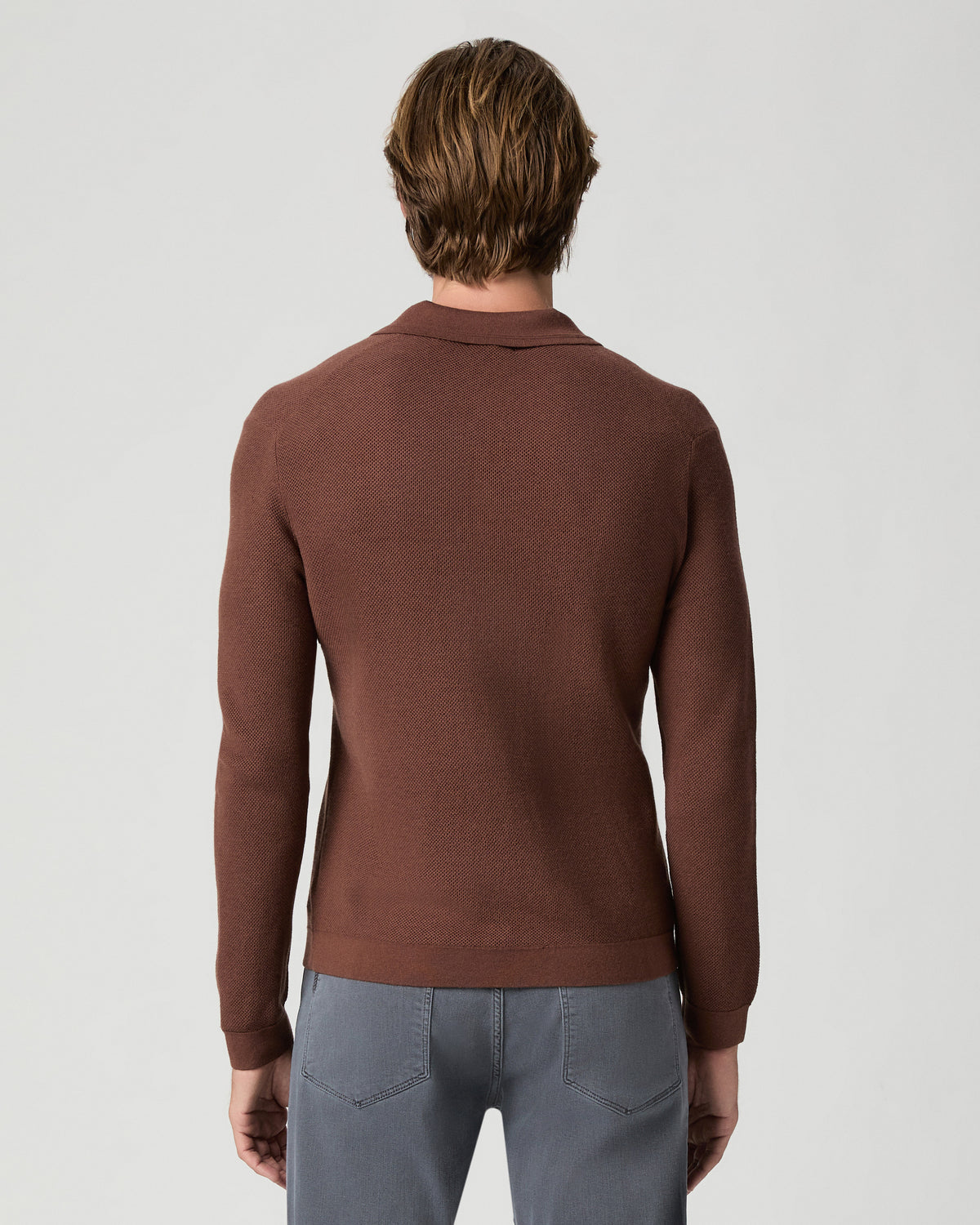 Back view of model wearing a reddish-brown knit polo with the Federal 32 Inch Slim Straight Jean in Vintage Icy River