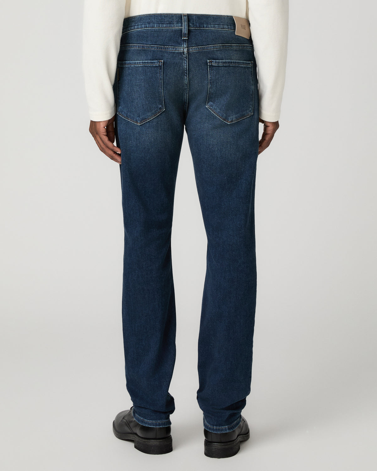 Rear full-length view from the waist down of the slim straight jeans, showing the back yoke and straight leg opening.