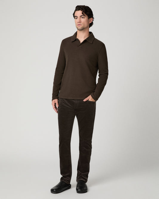 Man wearing brown shirt and brown pants against a white background