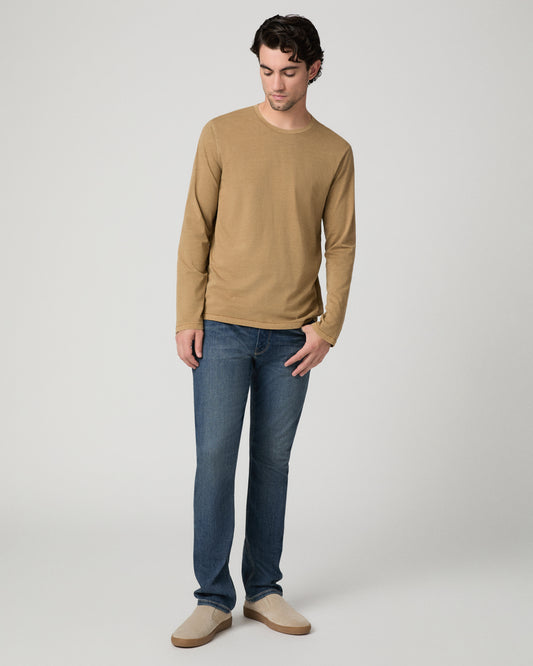 Man wearing beige and blue pants against a white background