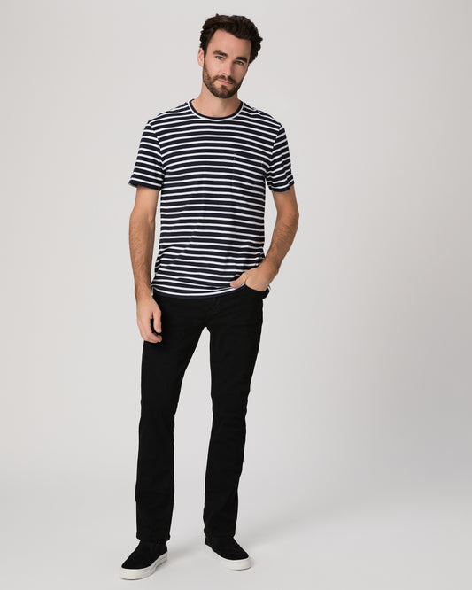 Man wearing a black and white striped shirt and black pants on a white background
