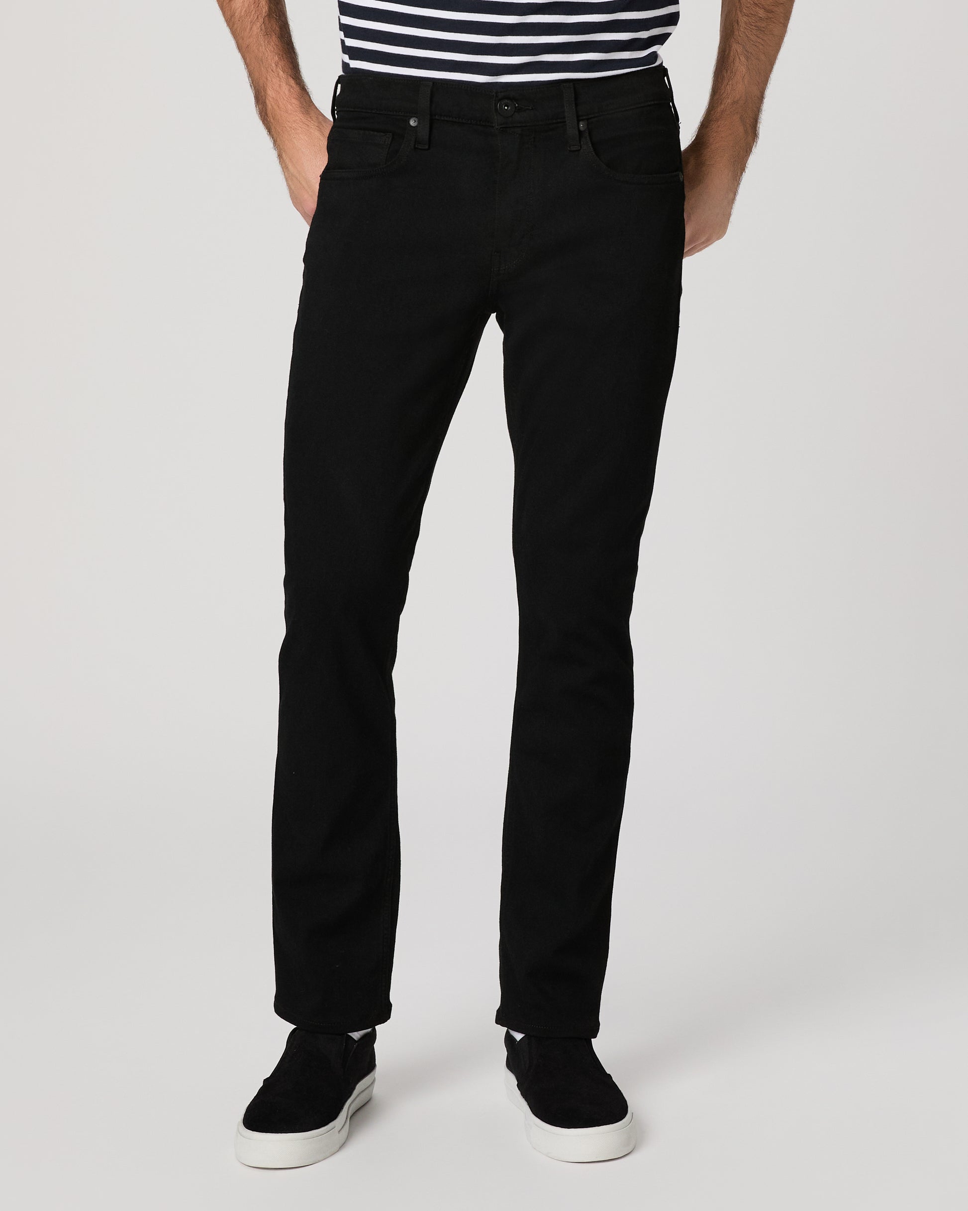 Man wearing a black and white striped shirt and black pants on a white background