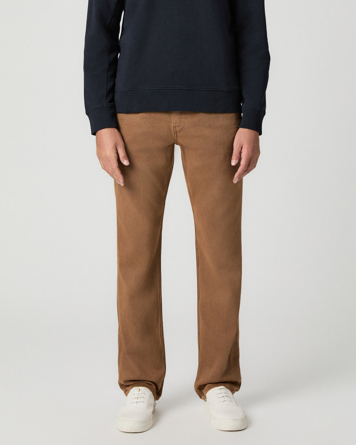Front view from the waist down of the Normandie 32 Inch Straight Leg Jean in Vintage Sierra Canyon, a tan wash, worn with a navy sweater and white sneakers