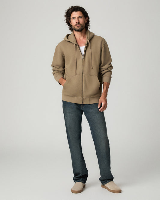 Full-length front view of a man wearing a tan suede shacket over a white tee, paired with dark indigo Whitaker-wash relaxed straight jeans featuring heavy heritage-style whiskering, and tan suede boots, standing with arms relaxed at his sides.