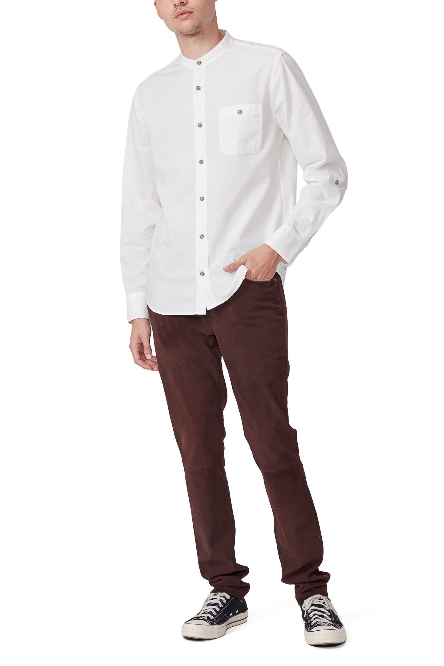 Person wearing a white shirt and brown pants on a white background