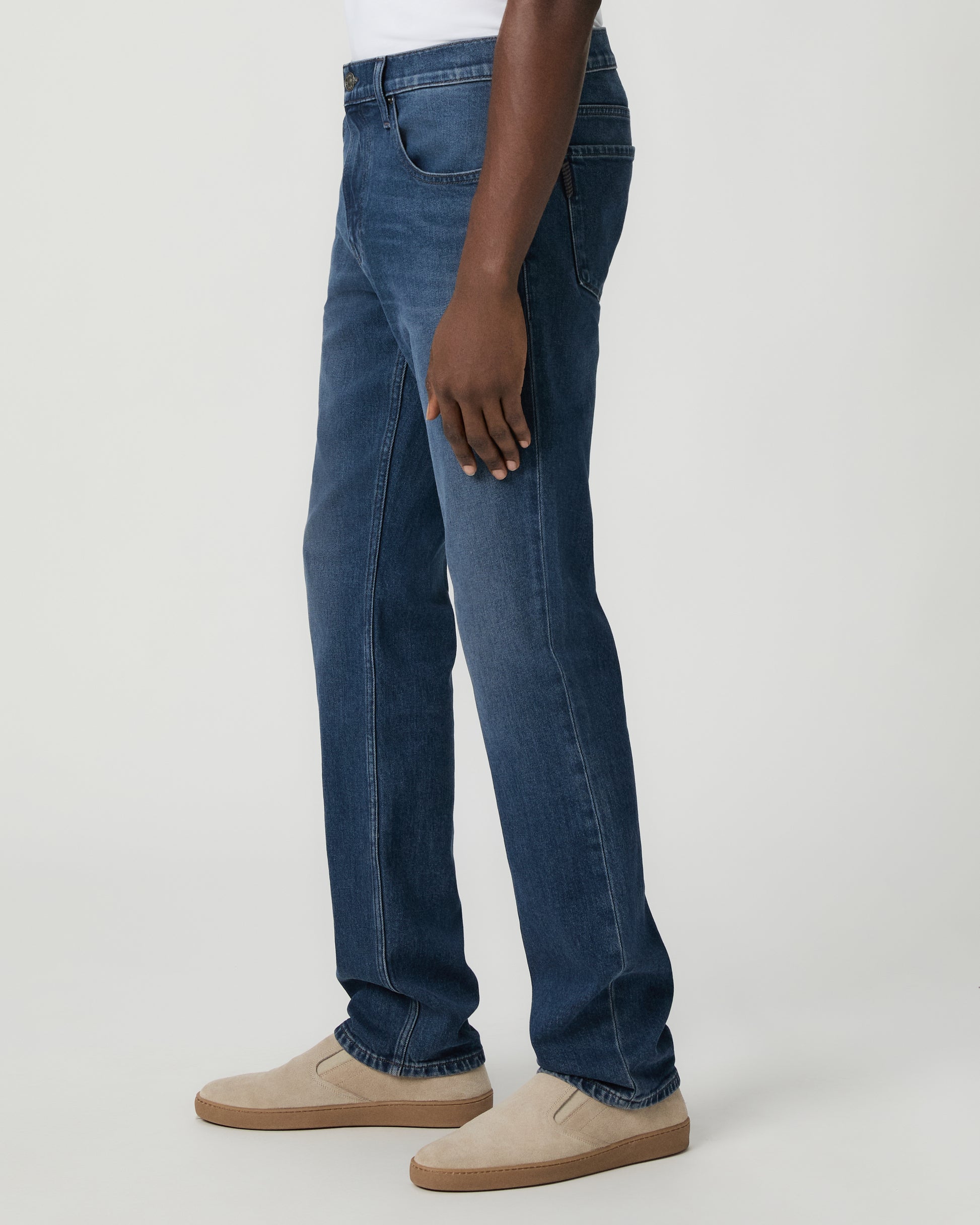 Man wearing a white shirt, and blue jeans on a white background