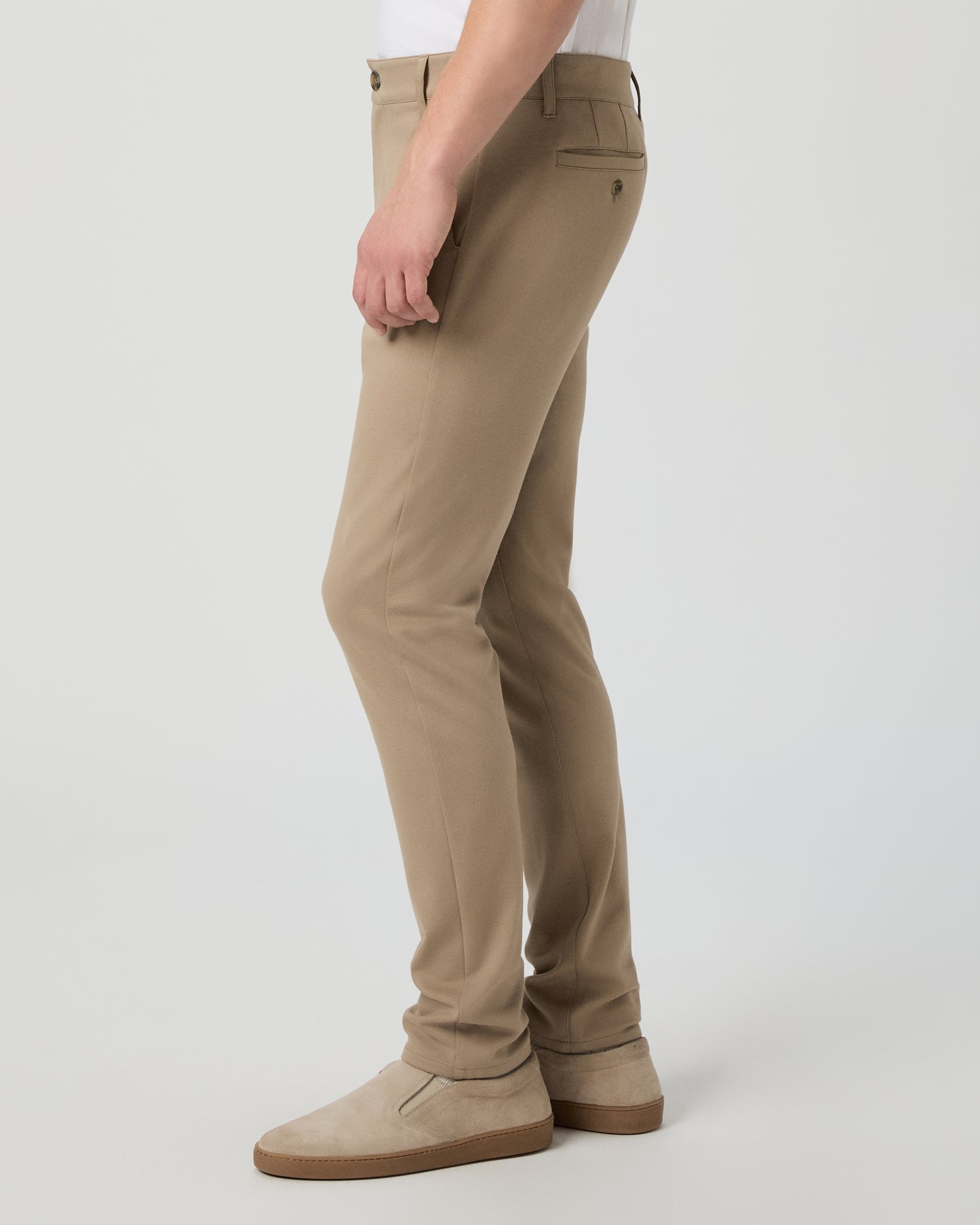 Man wearing a white tee and beige pants on a white background
