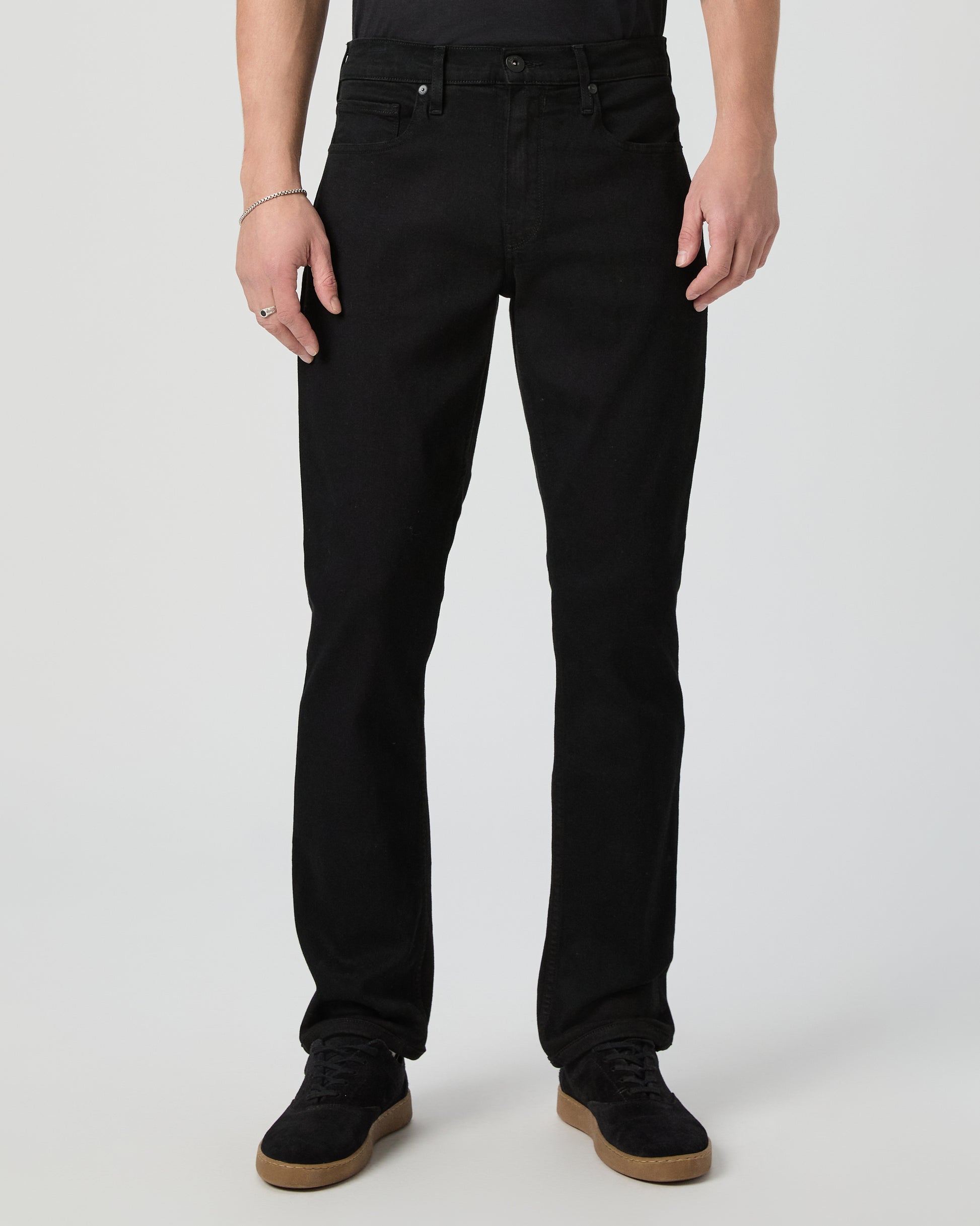 Man wearing a black tee and black pants on a white background