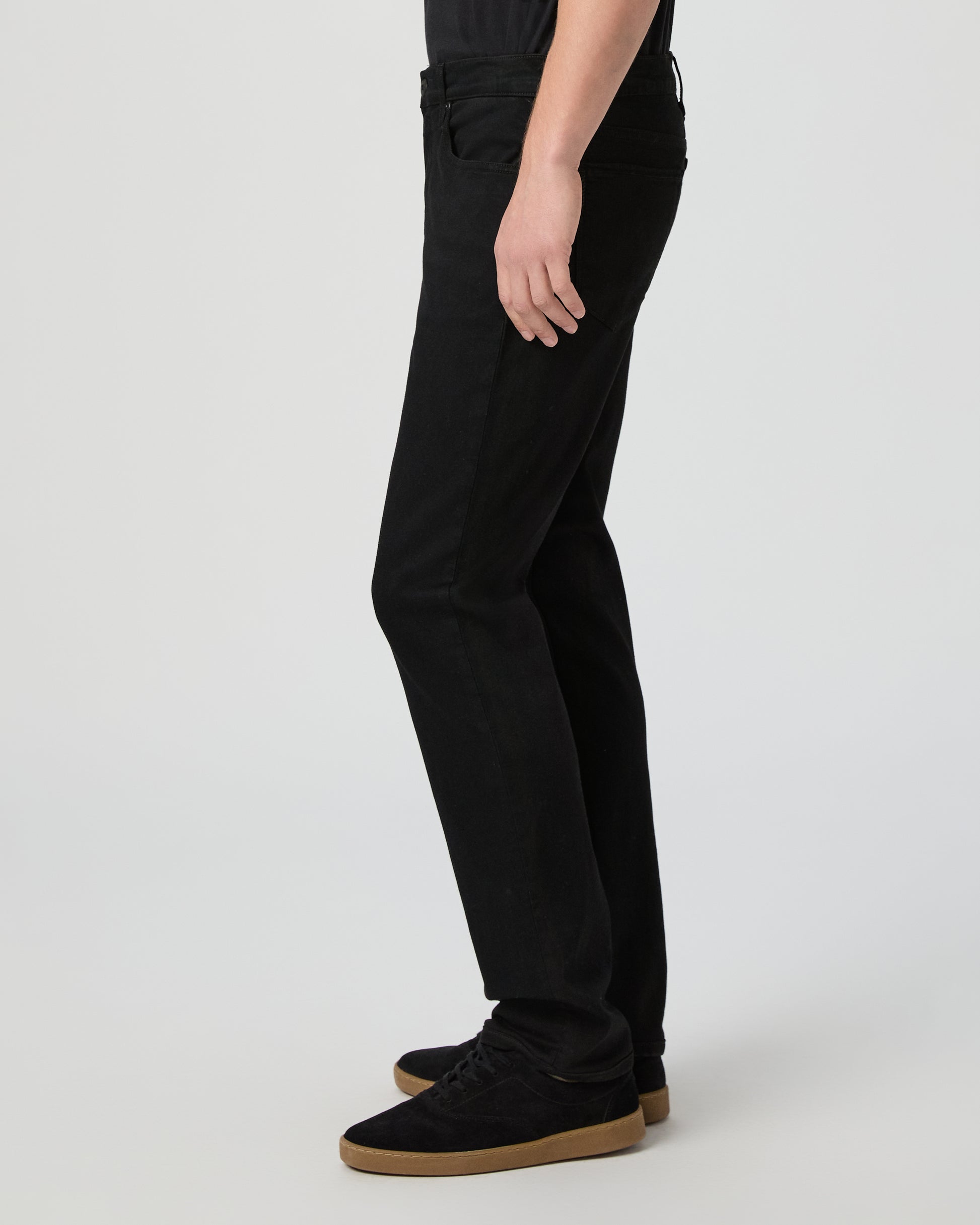 Man wearing a black tee and black pants on a white background
