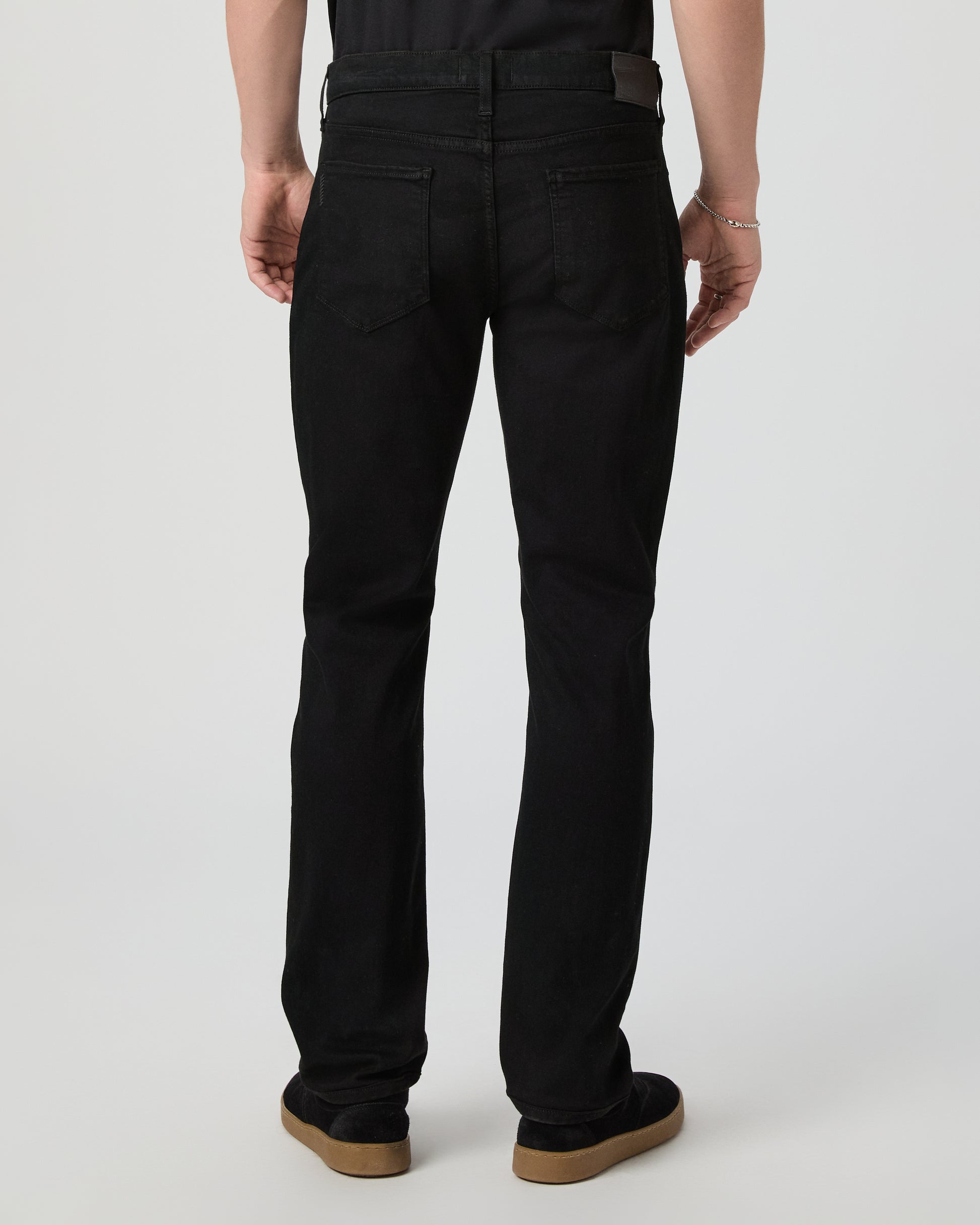 Man wearing a black tee and black pants on a white background