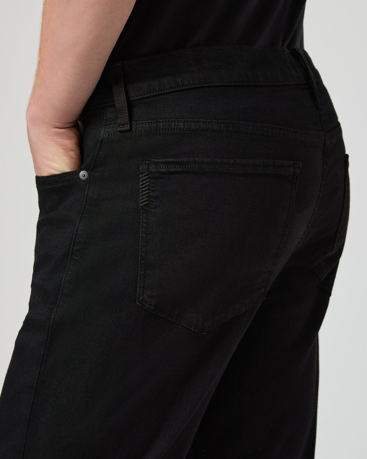 Man wearing a black tee and black pants on a white background