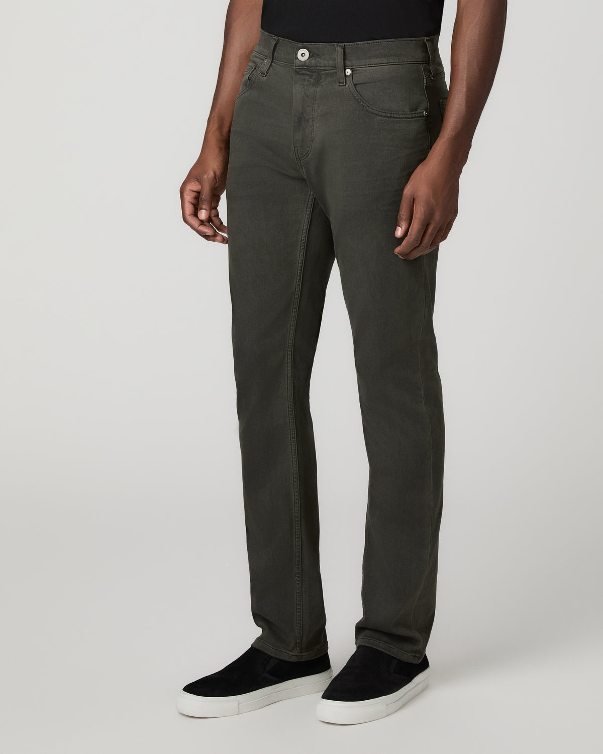 Angled three-quarter front view from the waist down showing the slim straight leg fit in the pigment-dyed greenish-black wash.