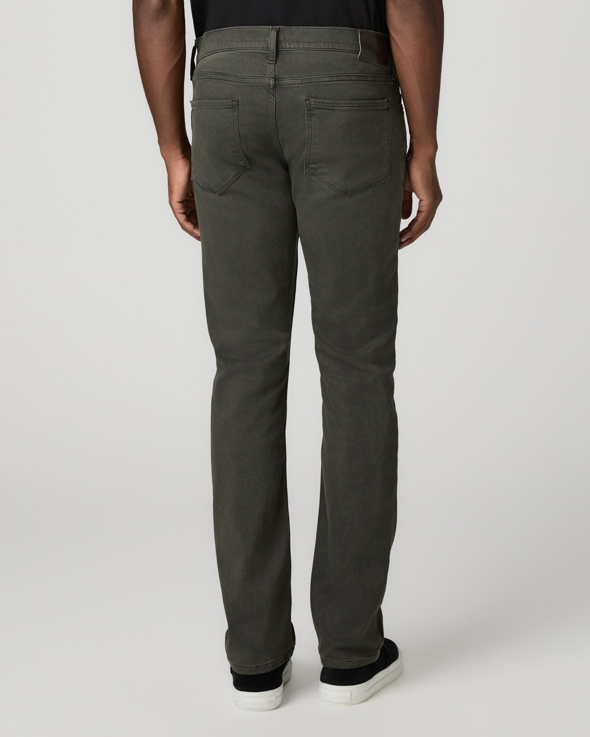 Rear full-length view from the waist down of the greenish-black slim straight jeans, showing the back pockets and straight leg opening.